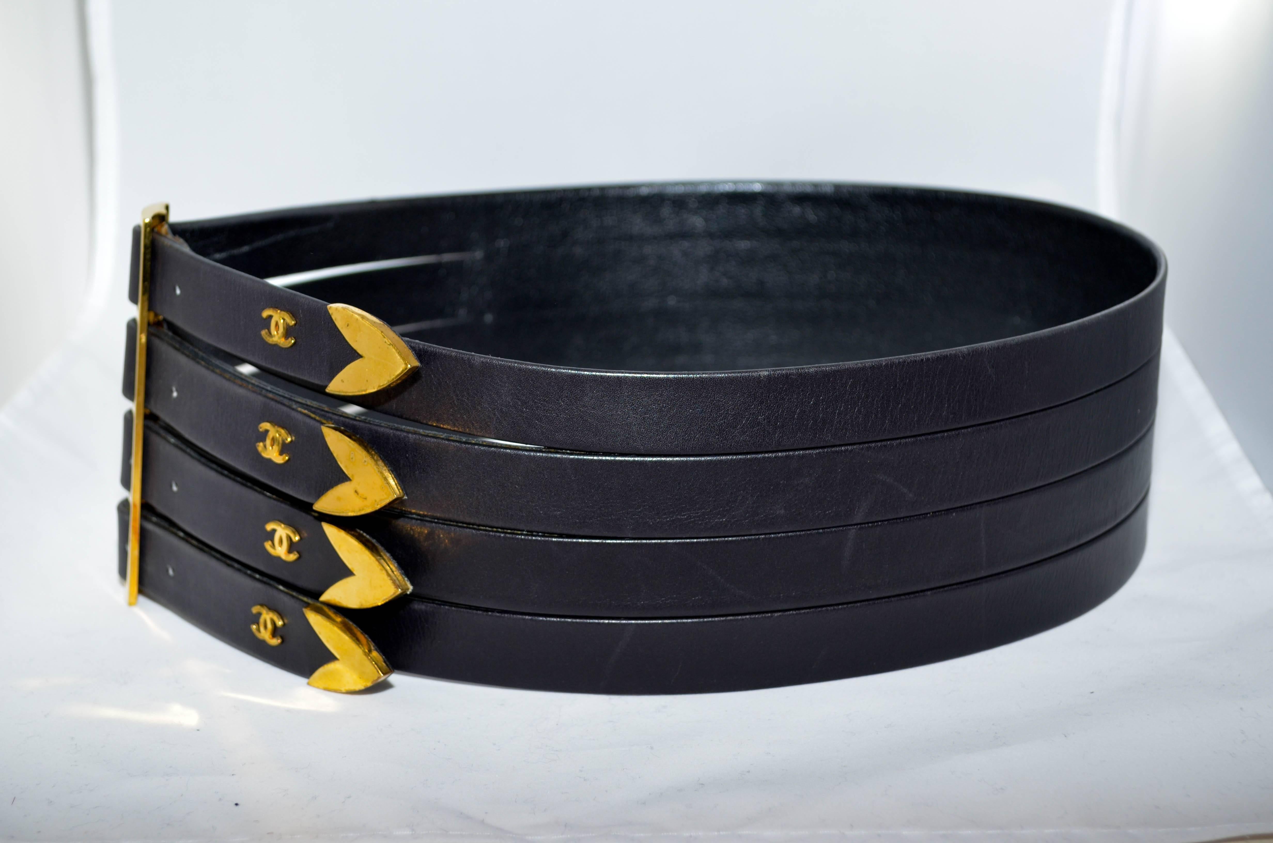 Fabulous and rare wide Chanel corset belt featuring four strips of leather 
 with 4 gold buckles and 4 gold  fasteners with gold tips and gold CC logos. Marked Chanel 85/34, Chanel, Made in France. From the 1980s, collection 29.
Measurements:
Total