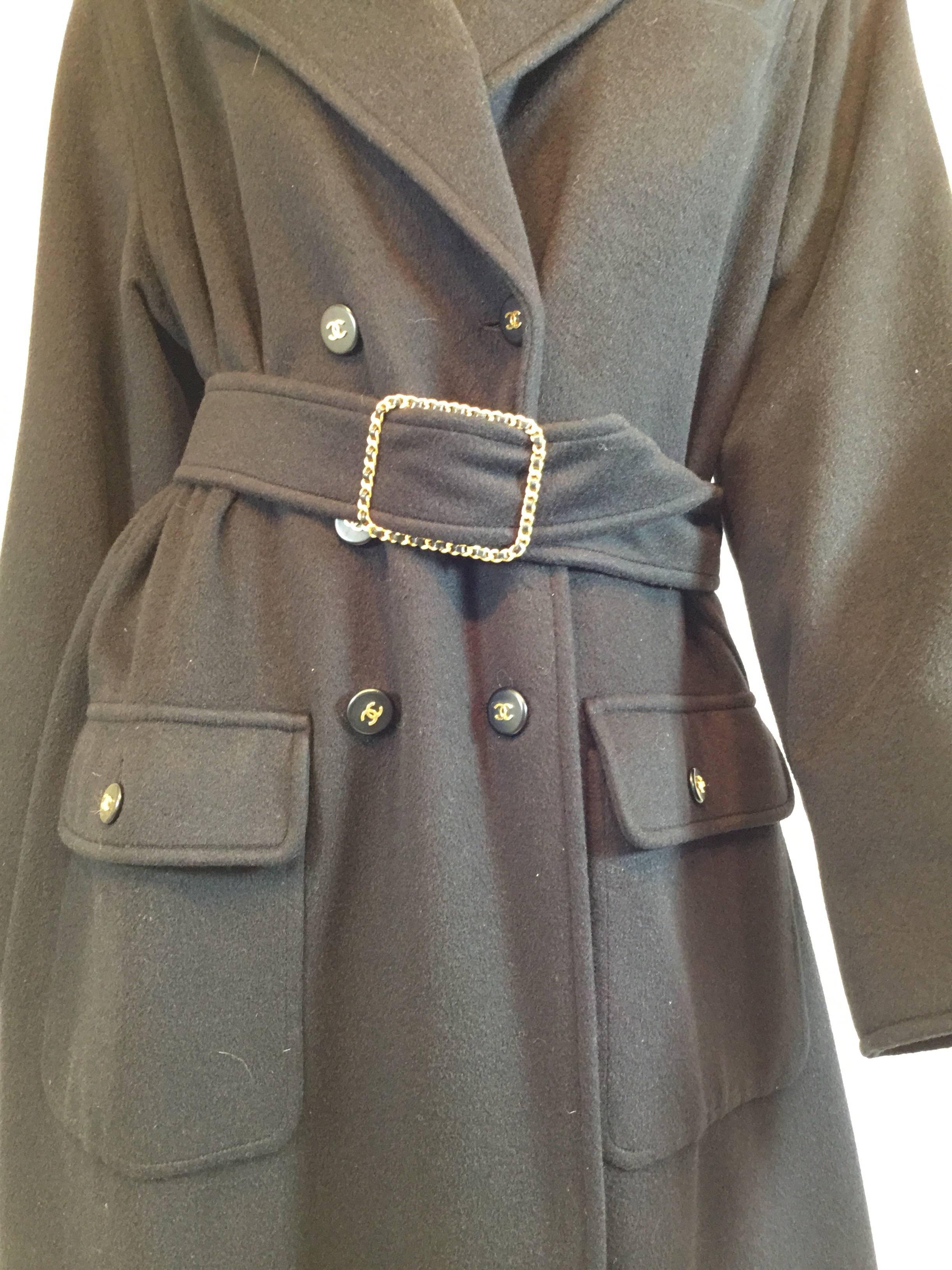 Chanel cashmere maxi coat estimated to be from 1999-2000 features chain around belt buckle with gold hardware and 6 black logo buttons down the front with gold CC centers. This is a winter coat, the cashmere is thick and is lined in silk. There are
