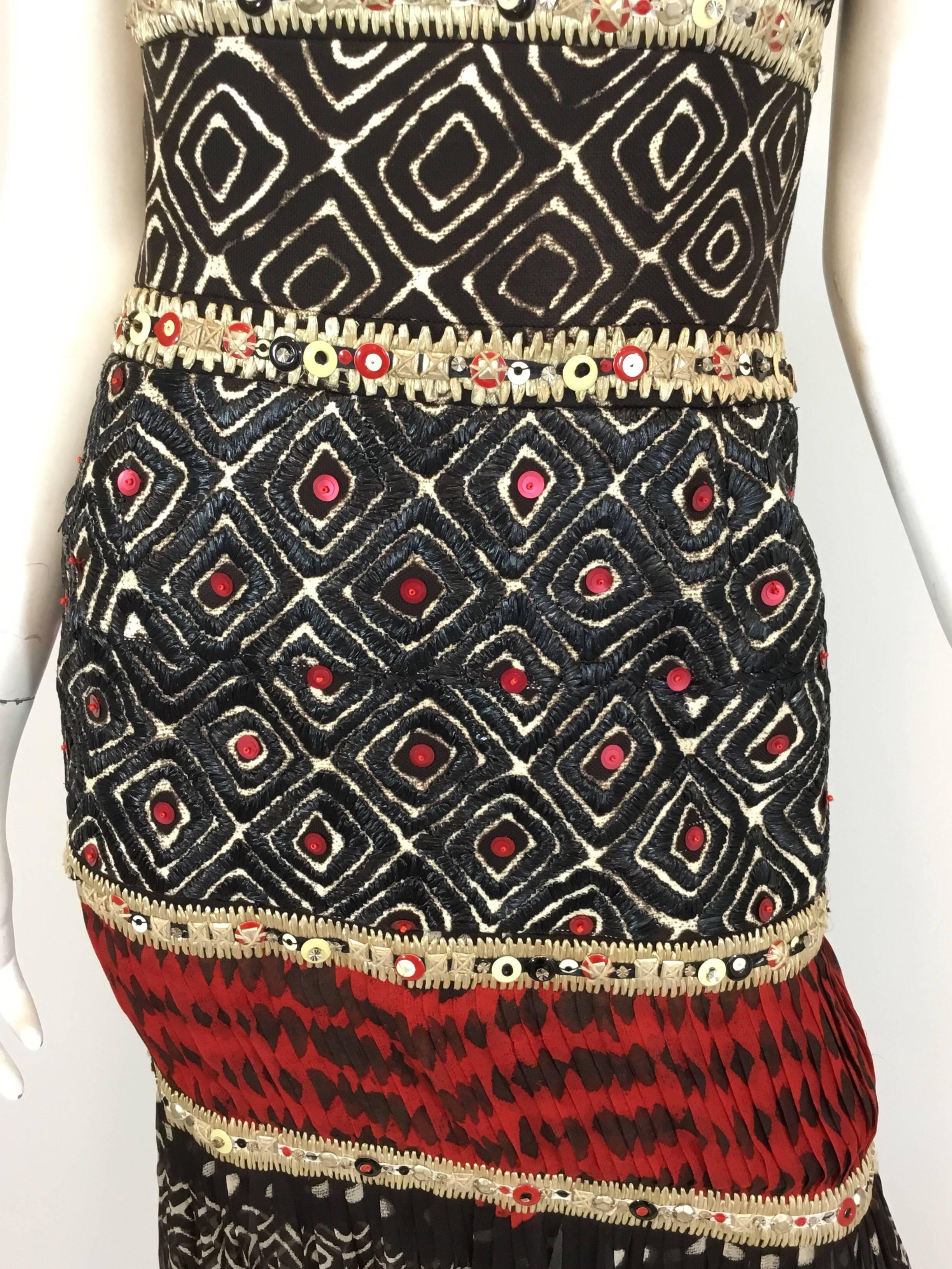 Oscar De La Renta spring 2008 collection tribal gown with raffia embroidery around hip area, enamel and metal sequins throughout and a silk chiffon skirt. Dress has a concealed back zipper closure and a boned bust for secure fit. 100% silk. Label