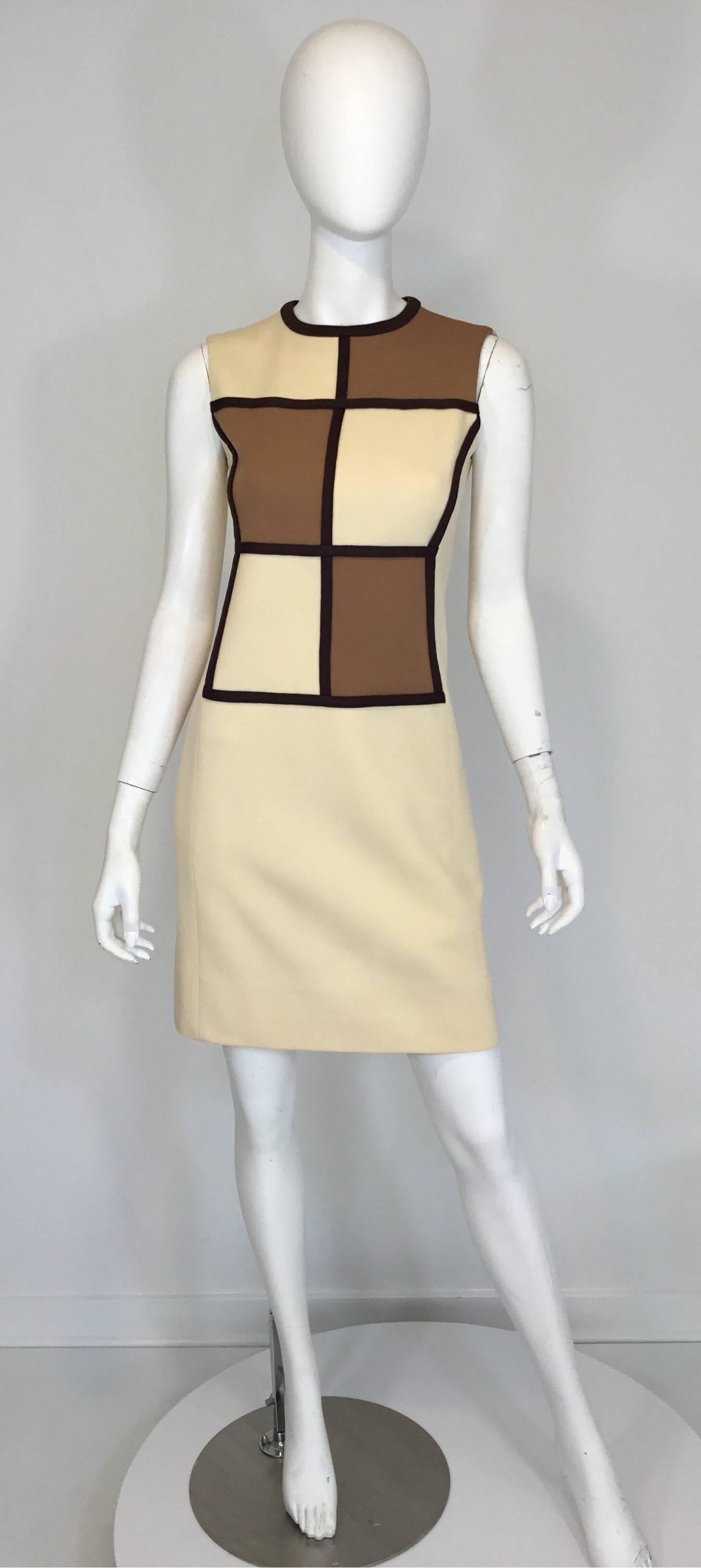Vintage Lilli Ann mod 1960's dress and coat set. Coat features a grid pattern in a brown/tan color combo with concealed snap button closures and slits at the sides of the hem. Dress has a back zipper closure as well as a hook-and-eye fastening. Both