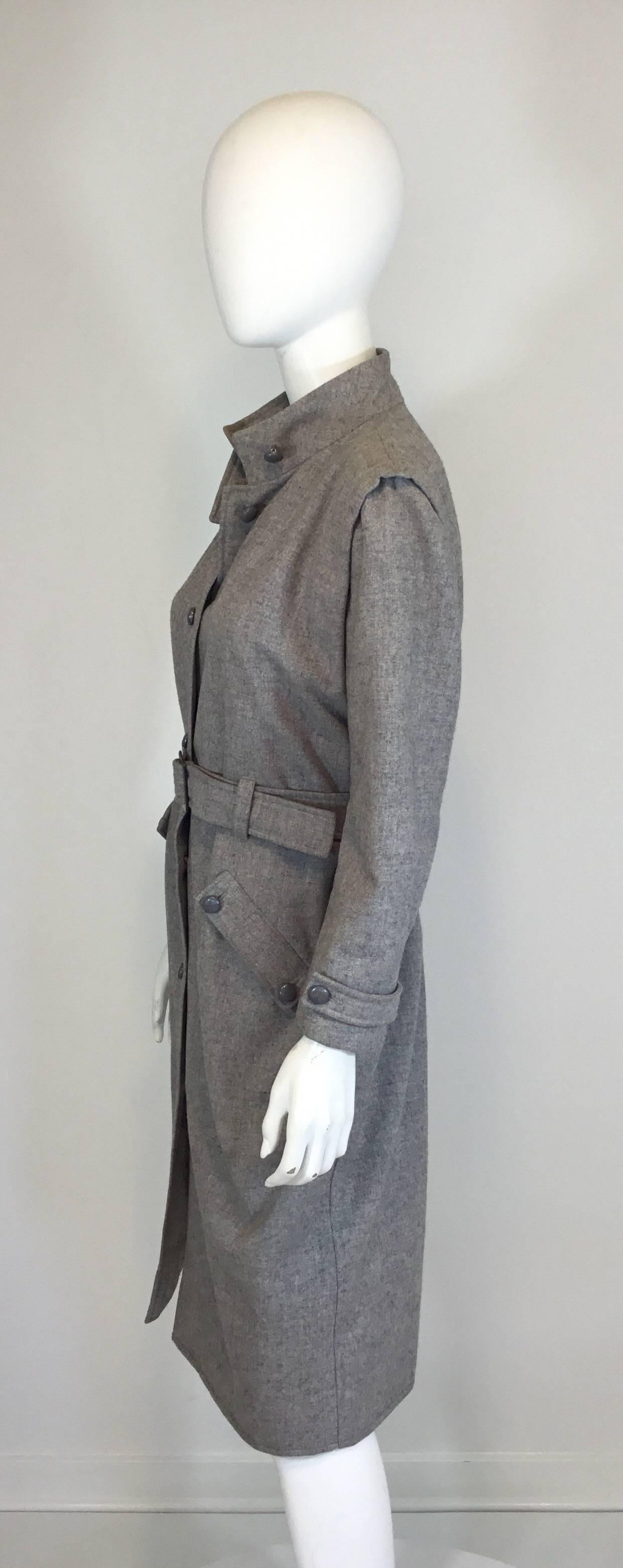 Vintage Andre Courreges coat made of 92% wool and 8% nylon with a button and belt closure, button pockets at the hips, and a full lining. Coat made in France.  Clean modern lines. Designer size 0 or modern size small. Measurements are:

Bust-