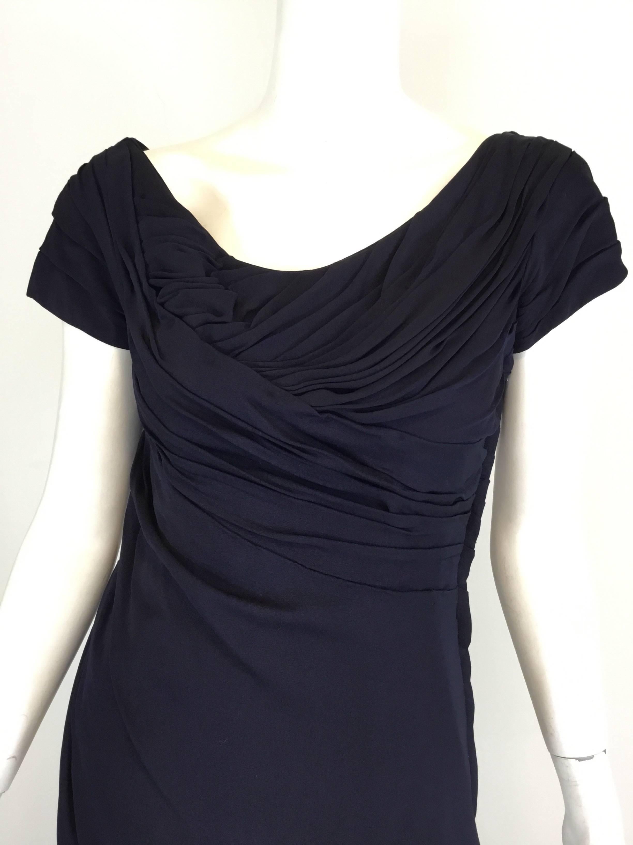 Vintage Ceil Chapman matte jersey dress in navy with a ruched upper bodice and a concealed side zipper fastening. Fully lined.

Measurements: Jersey has some stretch
bust 33'', waist 28'', hips 34'', length 41''