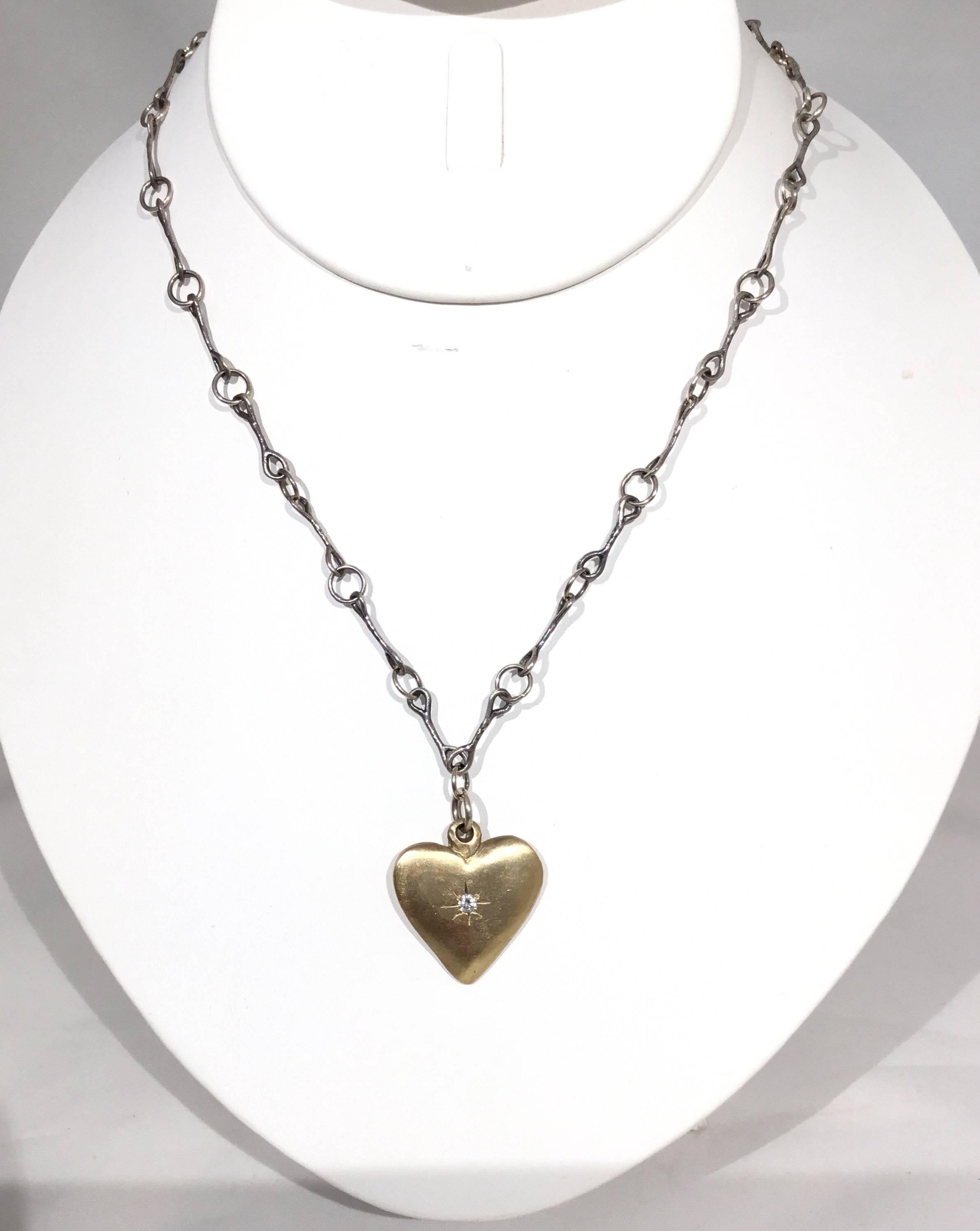 Jes Maharry sterling silver chain necklace features a gold heart shaped pendant with a diamond at the center and an engraved quote at the back that reads 
