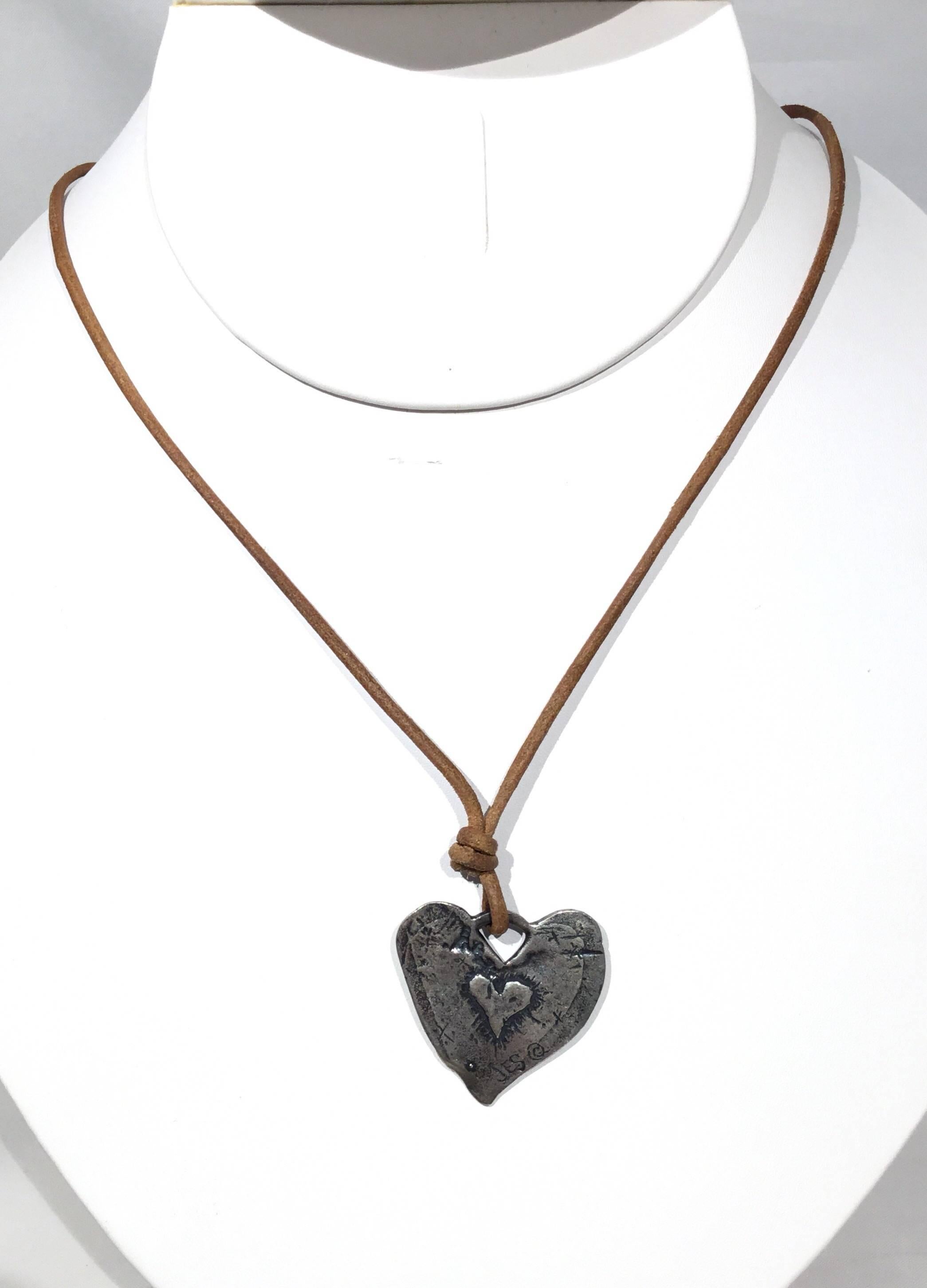Jes Maharry, Sundance Catalog designer suede leather necklace with a sterling silver heart pendant with an engraved angel, sterling clasp closure. Length approximately 8 inches circumference 16-18