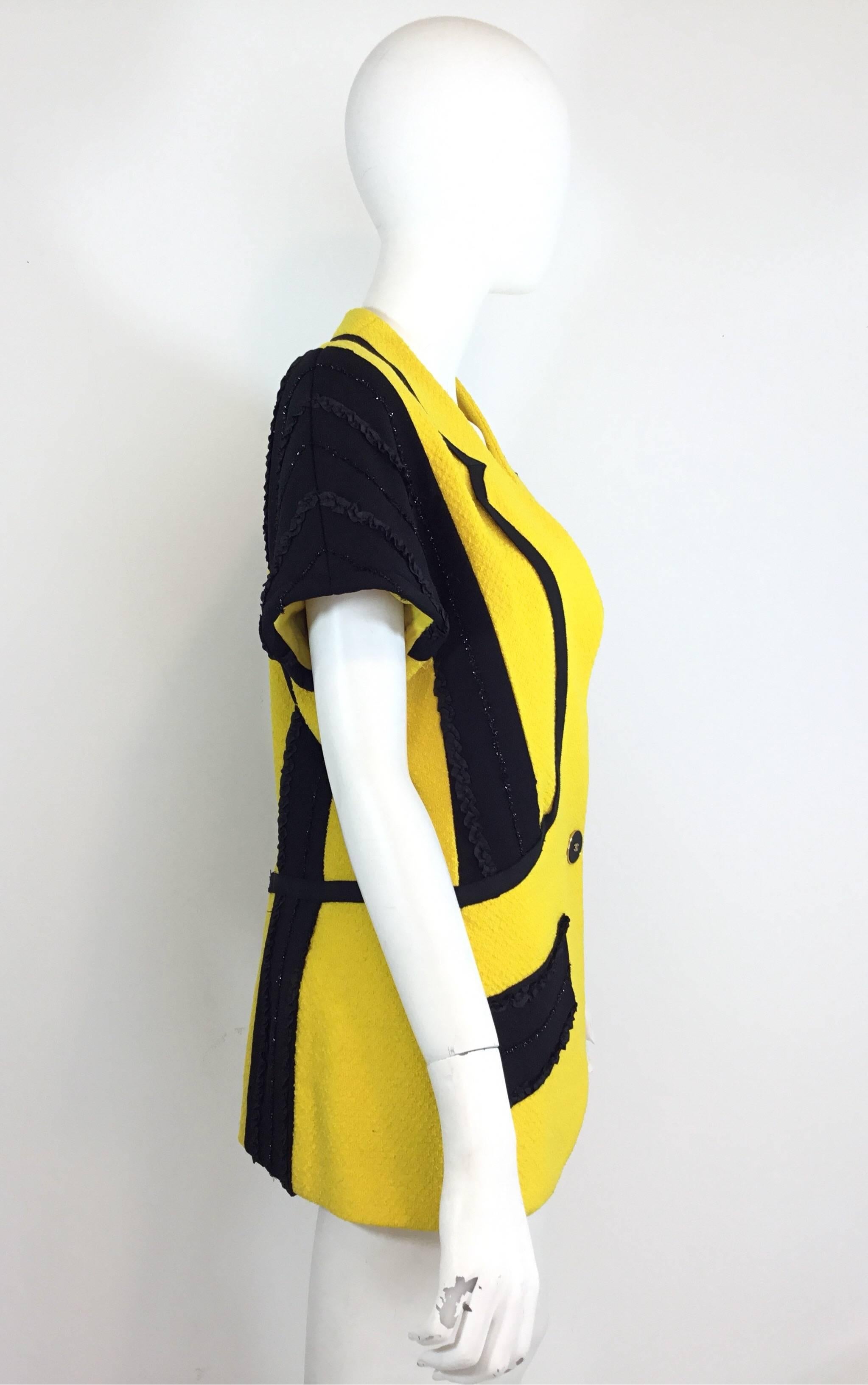 Chanel taxi cab yellow short sleeve jacket featured in yellow and black. Similar jacket is seen on Christy Turlington and Linda Evangelista in the ads for the collection. From collection 25, 1988. Jacket has one button fastening at the front center