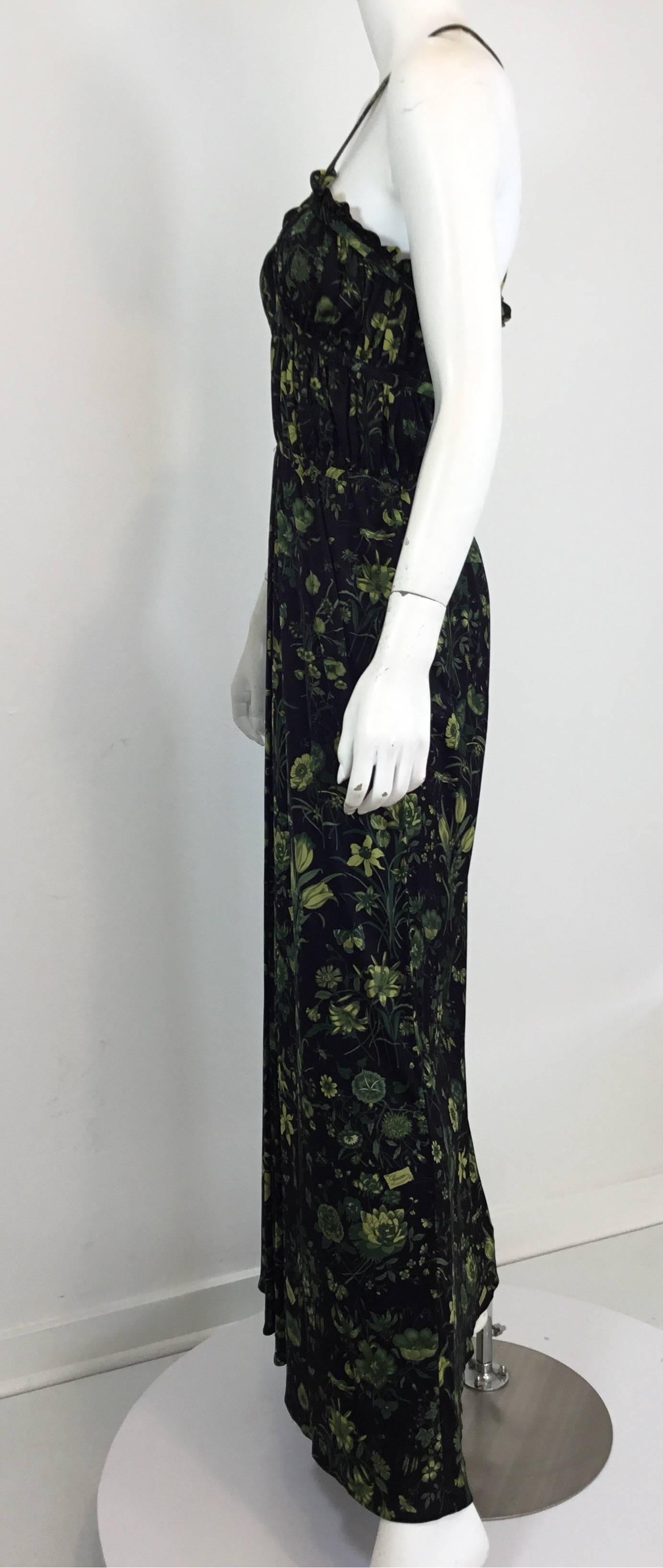 Gucci maxi dress in black with a green floral/butterfly print throughout, cross straps at the back, and a zipper fastening along the side. Dress is labeled a size 44, made in Italy. 65% acetate, 35% polyamide. 

Measurements: Jersey has stretch
bust