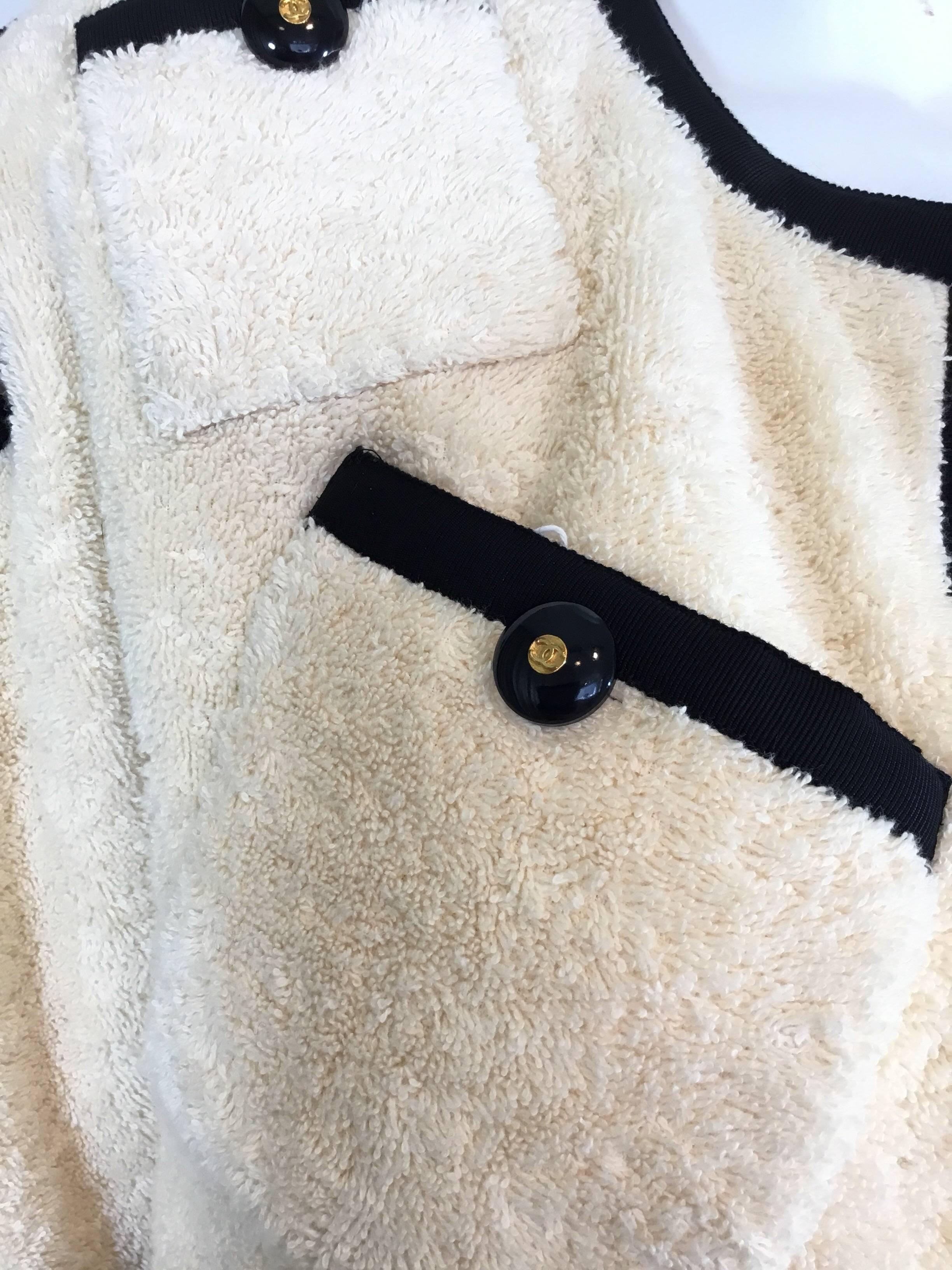 Rare Chanel jacket from collection 28 featured in an ivory terry cloth fabric with buttoned patch pockets all over. Jacket is 100% Cotton, lined in 100% silk, and has a black faille trim throughout. Labeled Size 38,  made in France. Jacket is in