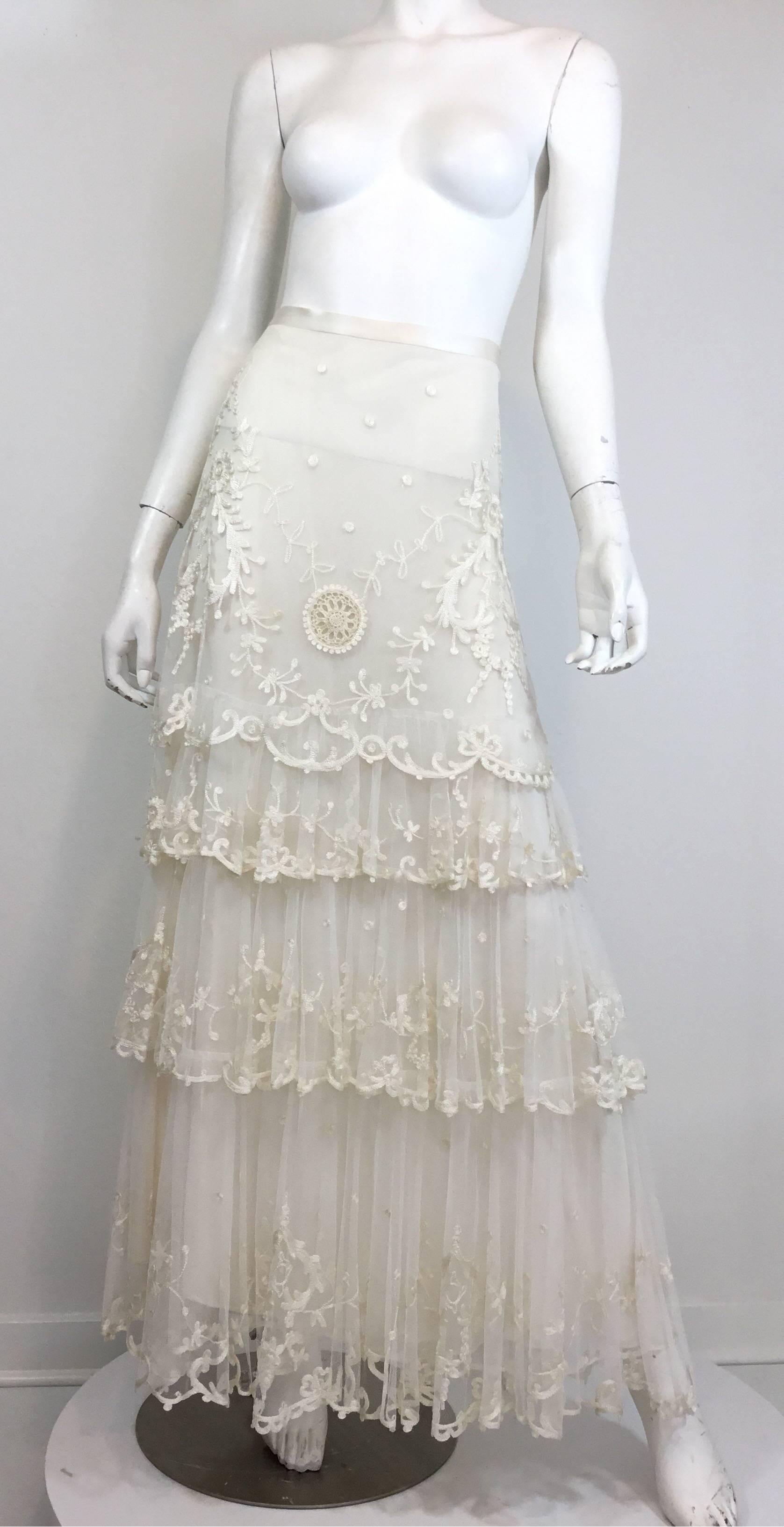 NEW Ralph Lauren skirt featured in a white lace mesh fabric with embroidery throughout, and a tiered design. Back zipper and button fastening. Skirt is a size 10, 100% polyester, retail $3,895, made in Hong Kong.

Waist 30'', hips 38'', length 43''