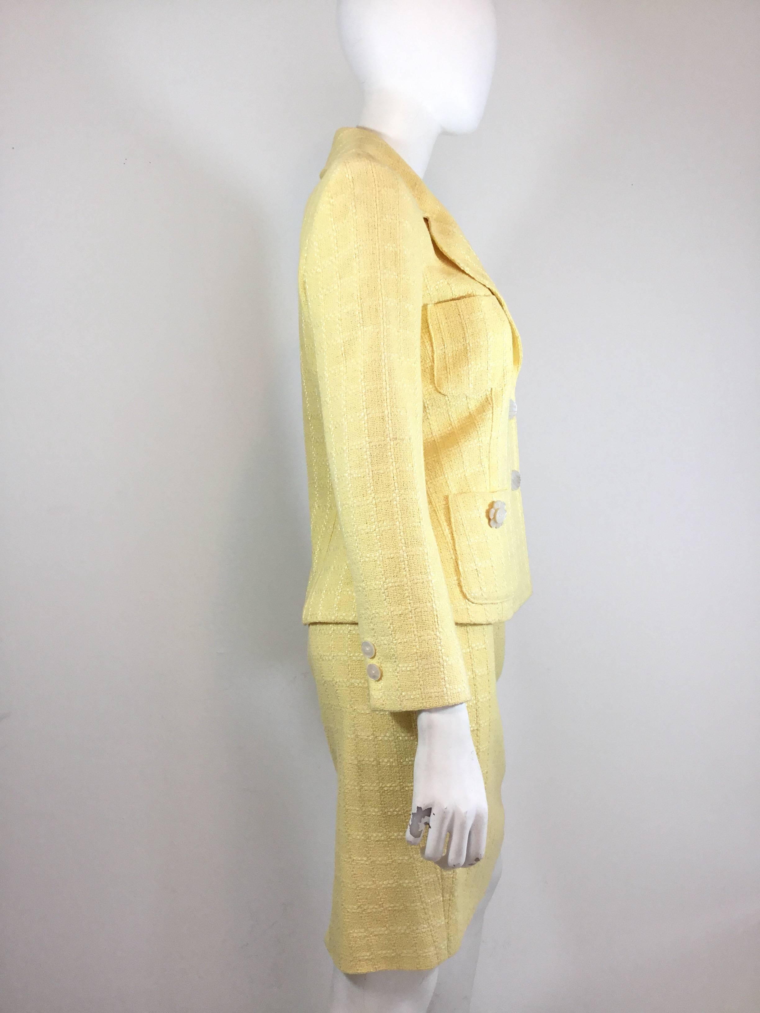 Chanel skirt suit featured in yellow. Jacket has button closures at the front and has a total 4 pockets. Skirt has a back zipper closure and is fully lined. Labeled size 38, made in France.

Jacket- 36”, sleeves 23”, length 25”
Skirt- waist 26”,