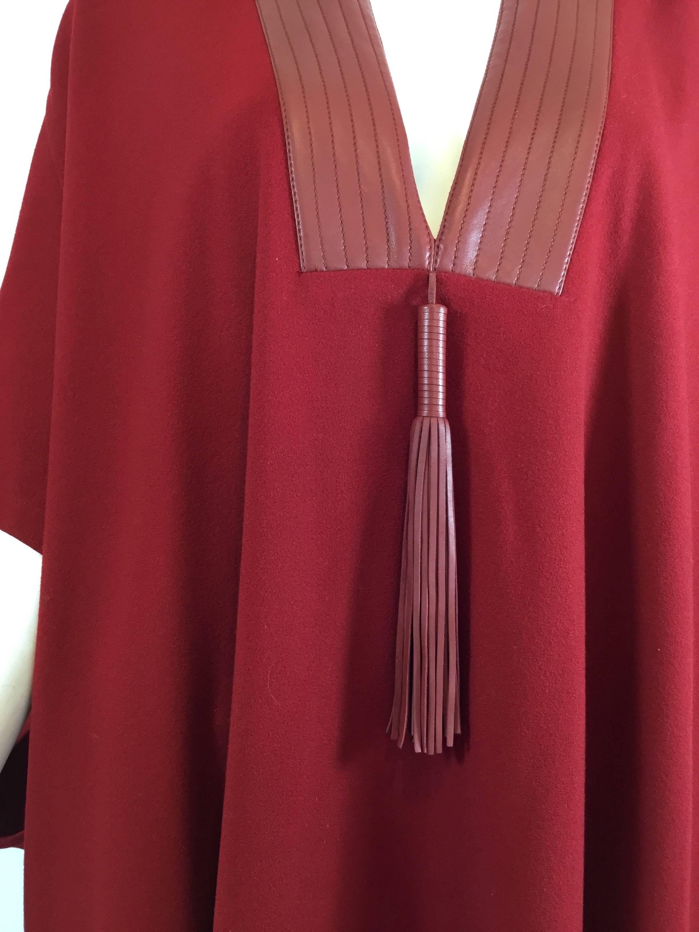 Hermes Cape in wool crepe with leather accents and tassel at the neckline. Cape is 100% wool and a labeled a size 38. Made in France. Cape was professionally hemmed for a shorter fit.

Bust 68” (flat across), length 38”