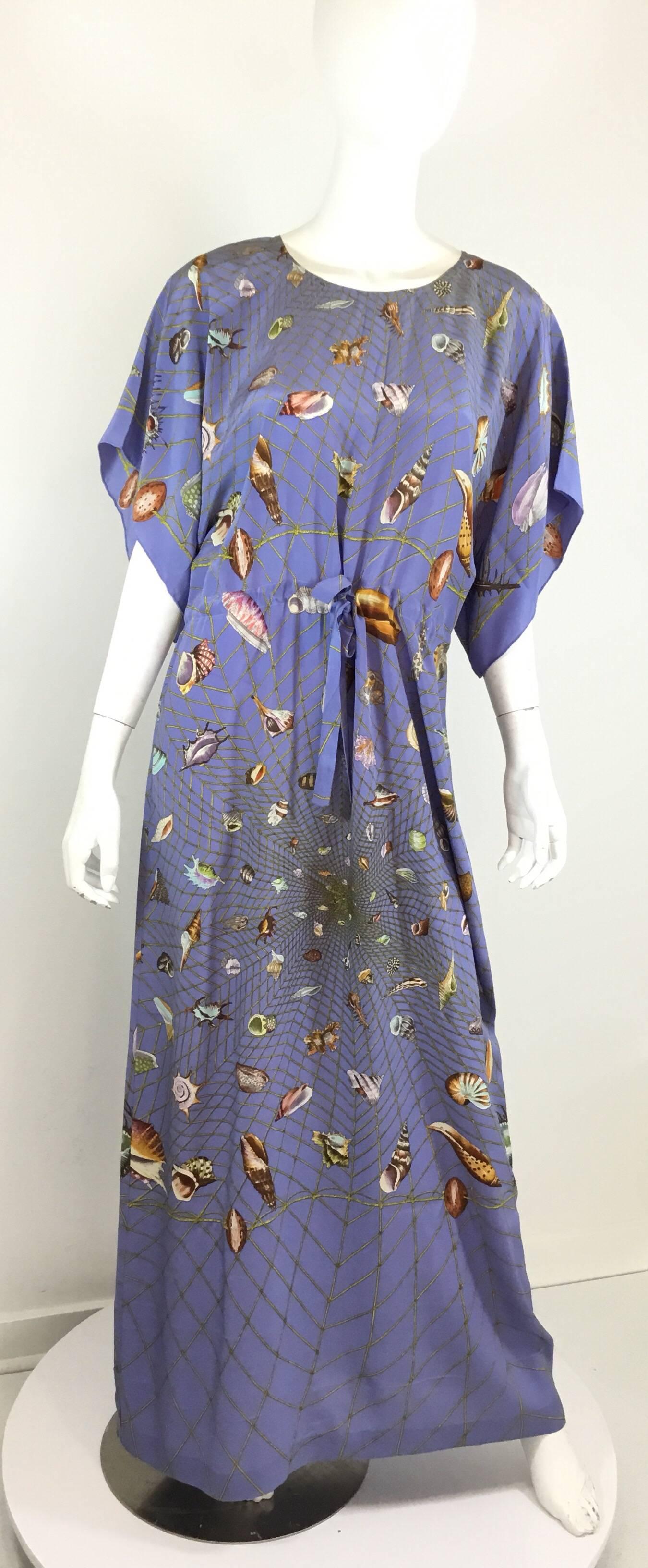 Vintage Gucci maxi dress features a sea shell print throughout the lavender-colored silk fabric, dolman style sleeves, and a drawstring waist tie fastening. Labeled size 44, made in Italy, 100% silk.

bust 41”
waist 38”
hips 43”
length 53”