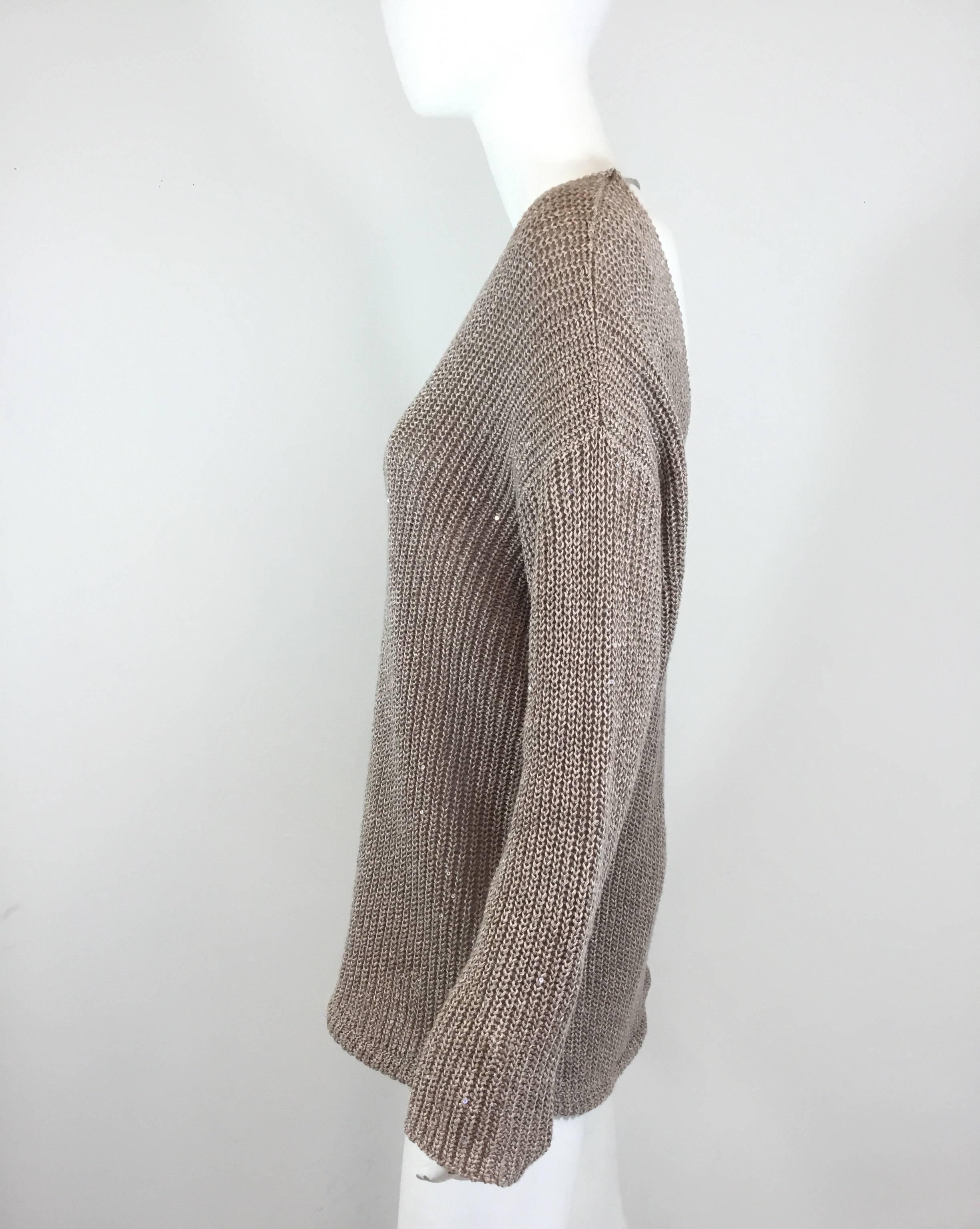 Brunello Cucinelli Sweater:

• Taupe sweater with subtle sequins throughout

• Open back with a string and button fastening across

• Drawstrings at the hem

• Bust 41”, sleeves 21”, length 19”