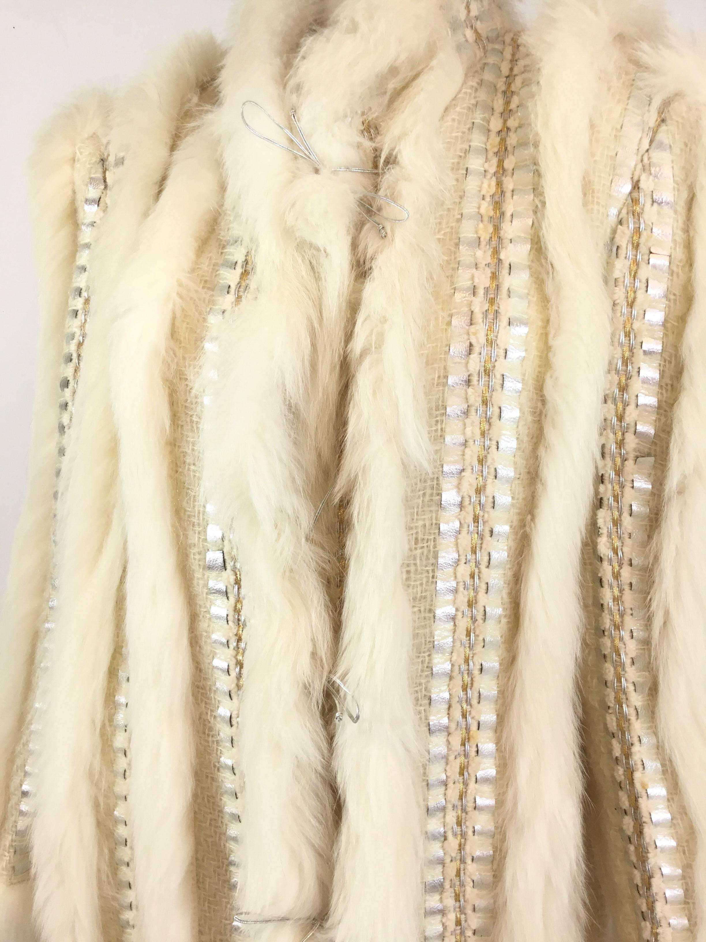 Long fox fur and Loose weave mohair coat features silver string tie closures along the front, Gold and silver braid embellishments, silver metallic leather embellishments and a full lining. Artist hand made, art to wear. Vintage 1980's. Labeled size