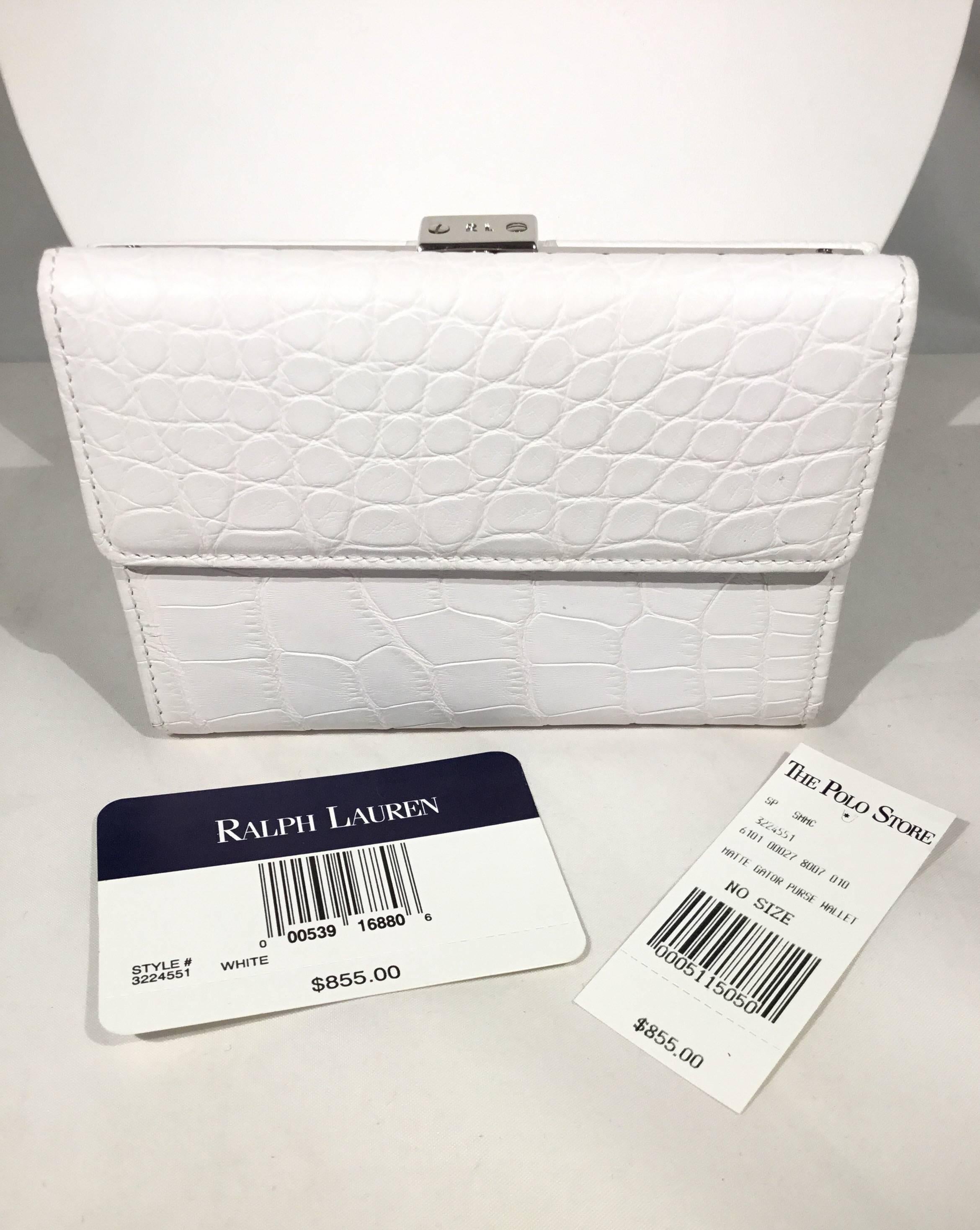 Ralph Lauren Croc Wallet: Smaller purses require smaller wallets.

• matte white crocodile wallet

• Snap flap opening with 6 credit card slots, 4 misc slots, and a slot for bills.

• Silver tone metal closure for coin slot

• Retail $855

• 5” x 1”