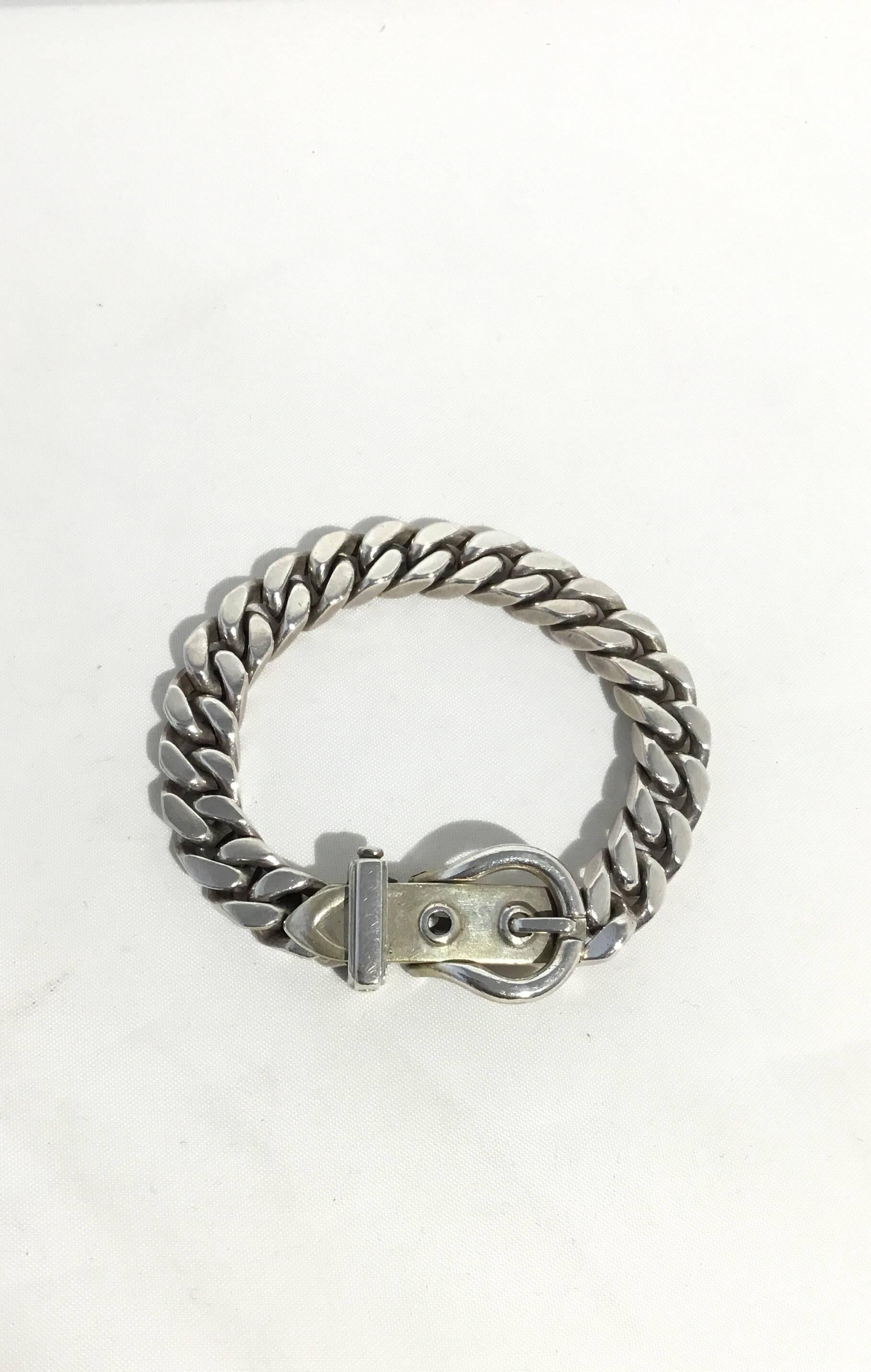 Vintage Hermes bracelet features in Sterling Silver with a buckle design. Bracelet measures approximately 8 inches long. (7” from buckle closure to smallest size, 7.5” from buckle to largest size).  Normal wears.