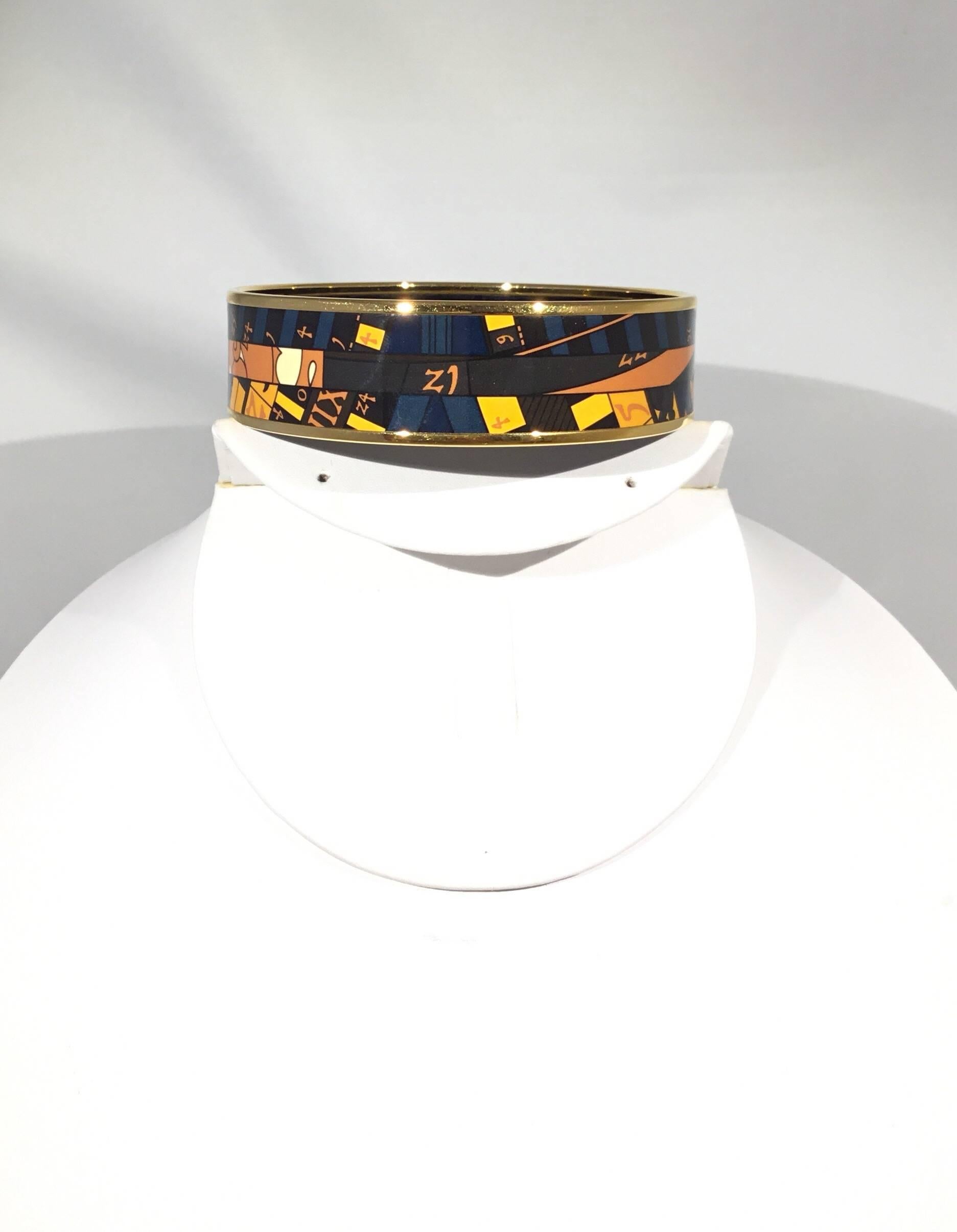 Hermes bangle featured in a Multicolor Enamel Print with gold hardware. Made in France + Q. Diameter 2.75”, width 0.75”.  Bangle includes box and dust bag. 