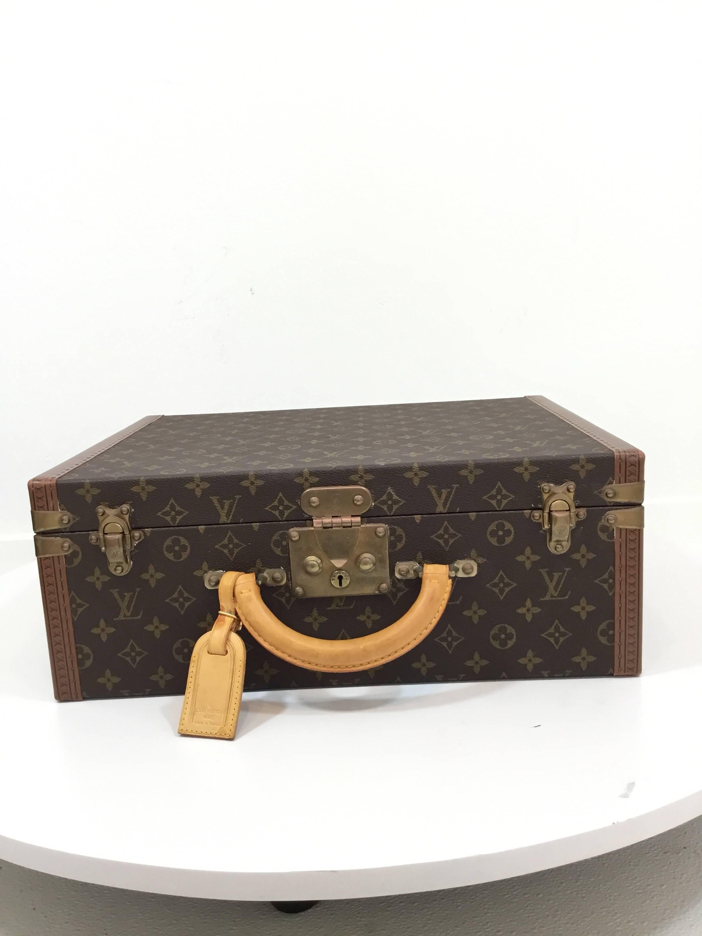Brown and tan Louis Vuitton monogram coated canvas Super President briefcase with brass hardware, vachetta leather top handle and double flip-lock and center push-lock closure. Green Taiga leather detailed interior. Green cloche with key. Exterior