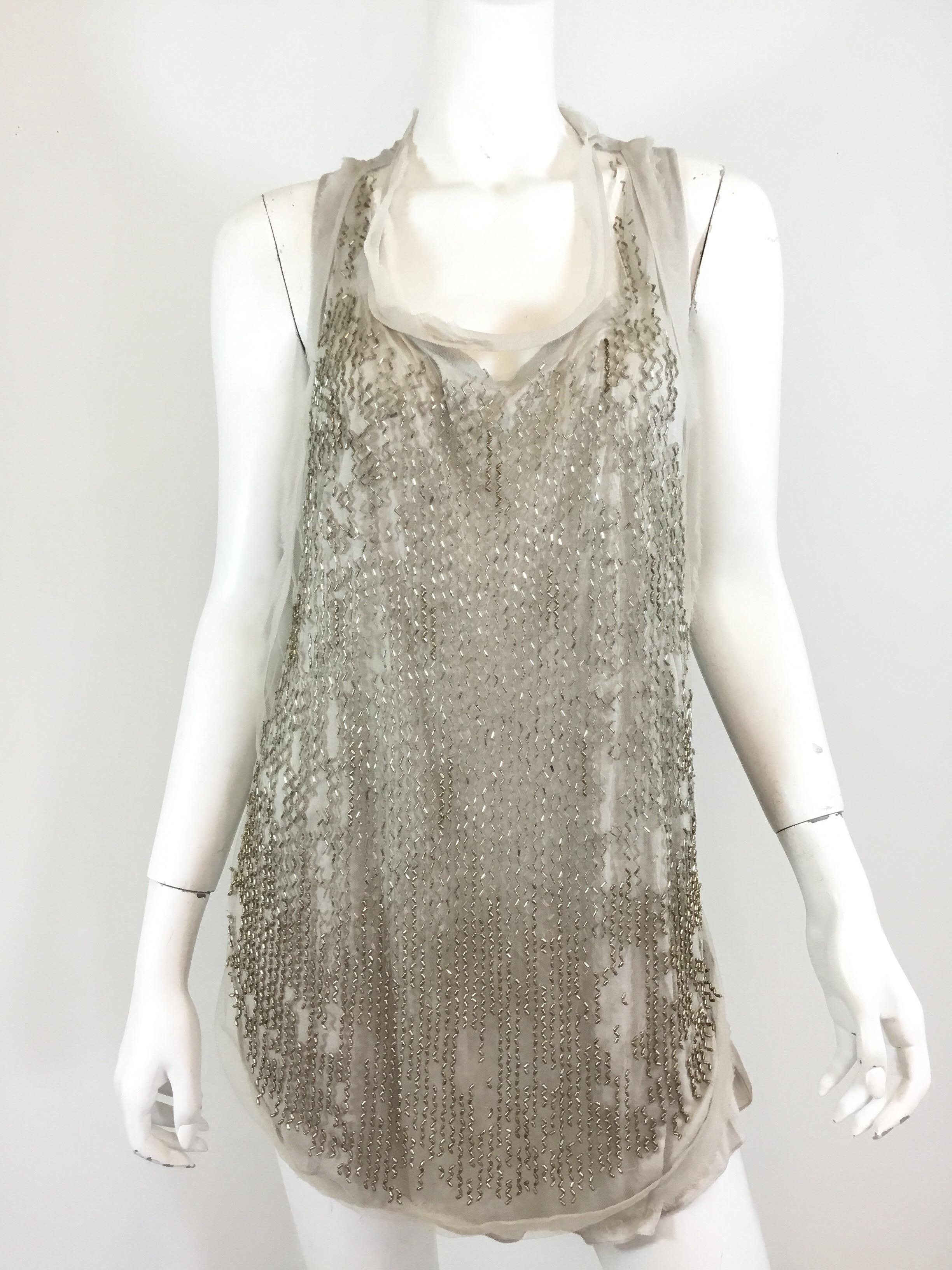Roberto Cavalli beaded racer back tank top. Top has two layers — bead with mesh and a solid layer underneath. Made in Italy. Top is labeled Size 46.
Great condition.

Bust 40”
Length 27''