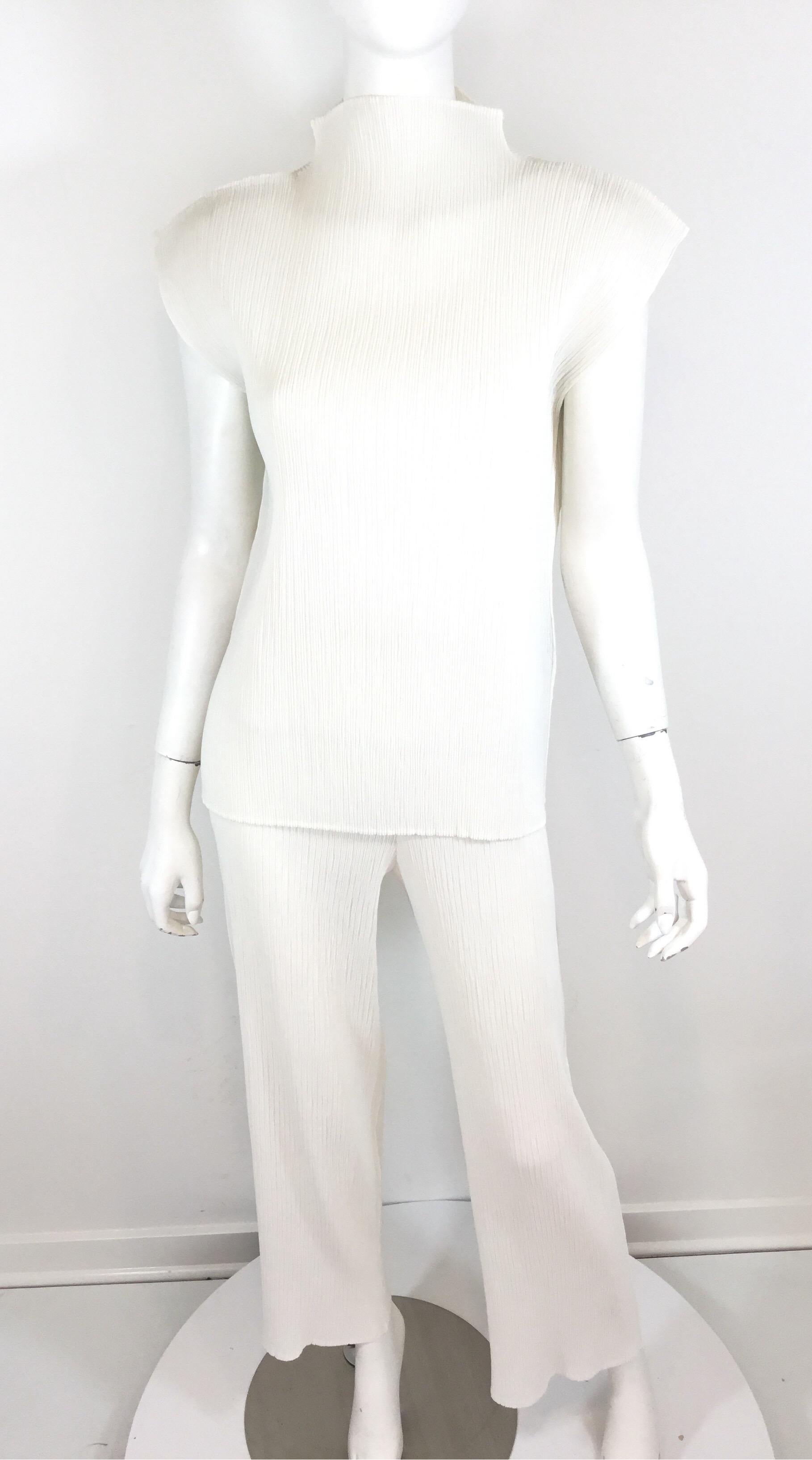 Issey Miyake Pleated Pant + Top set in white, size small. Composed of 100% polyester. Pants have elastic band around the waist. Made in Japan.

Measurements:
Top- bust 37'' (with stretch), length 26'', shoulder to shoulder 19''

Pants- waist 24''