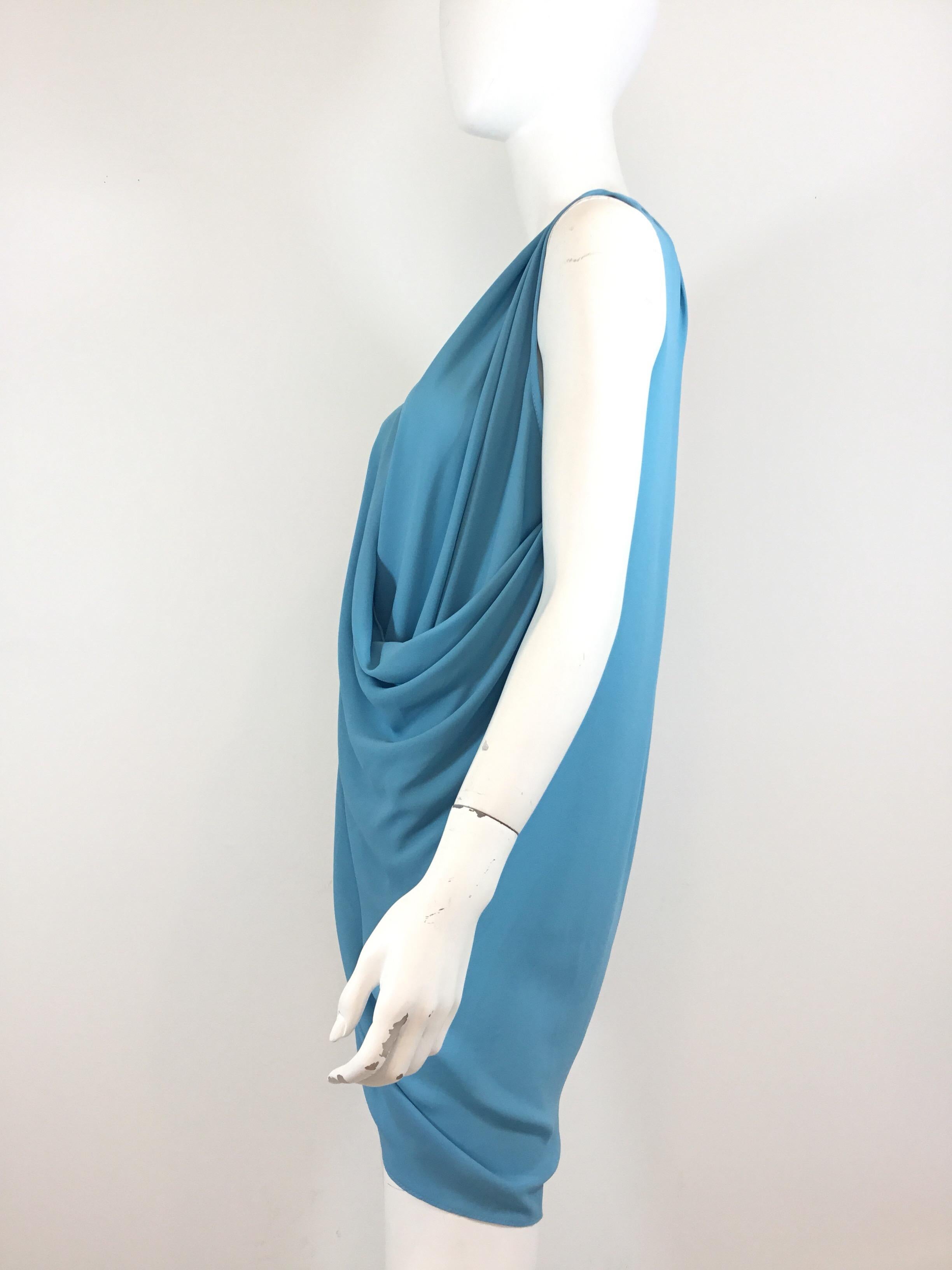 Gianni Versace vintage mini dress/tunic featured in an soft blue with a draped/cowl neckline, and is labeled size 44. Made in Italy. Dress is composed of a viscose-rayon and polyester blend. 

Measurements:
bust 40'', length 34'', waist measures