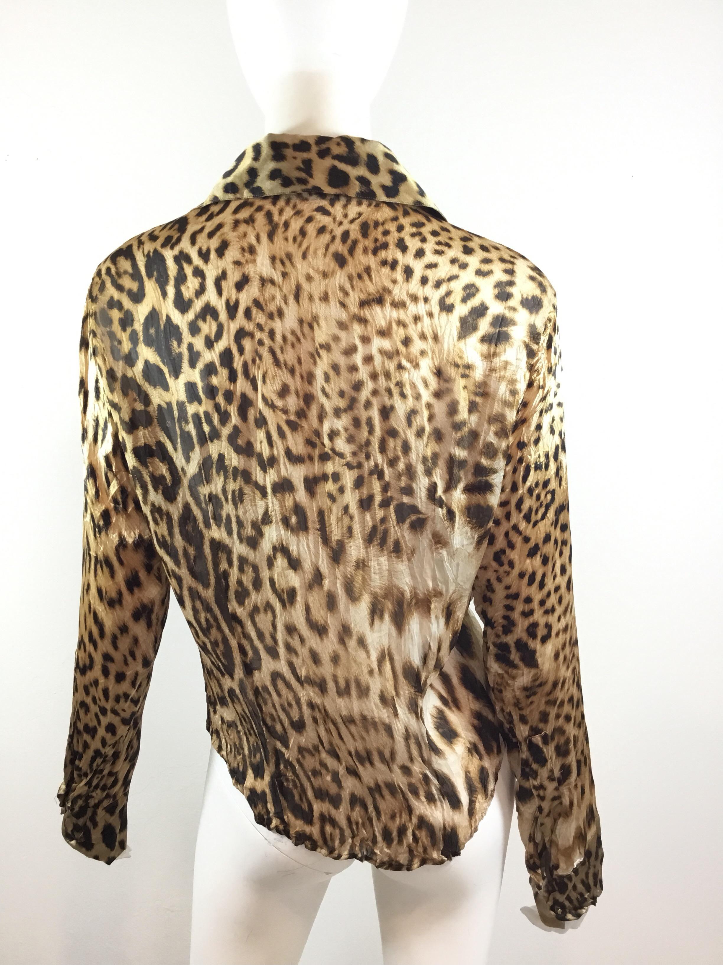 Roberto Cavalli blouse features a leopard print with goldtone button closures along the front and on the cuffs as well. Composed of 100% silk, made in Italy, labeled Size XL.

Bust 44”, sleeves 24”, length 25”, shoulder to shoulder 17”