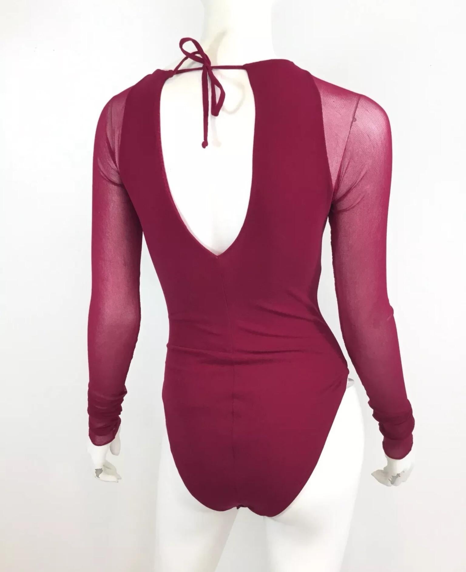 Vintage Giorgio di Sant Angelo sticking knit bodysuit in a raspberry color with a back tie closure and snap fastenings. Bodysuit is in excellent vintage comdition with no major wears.

Bust 28”, sleeves 29”, waist 21” (stretch to the fabric)