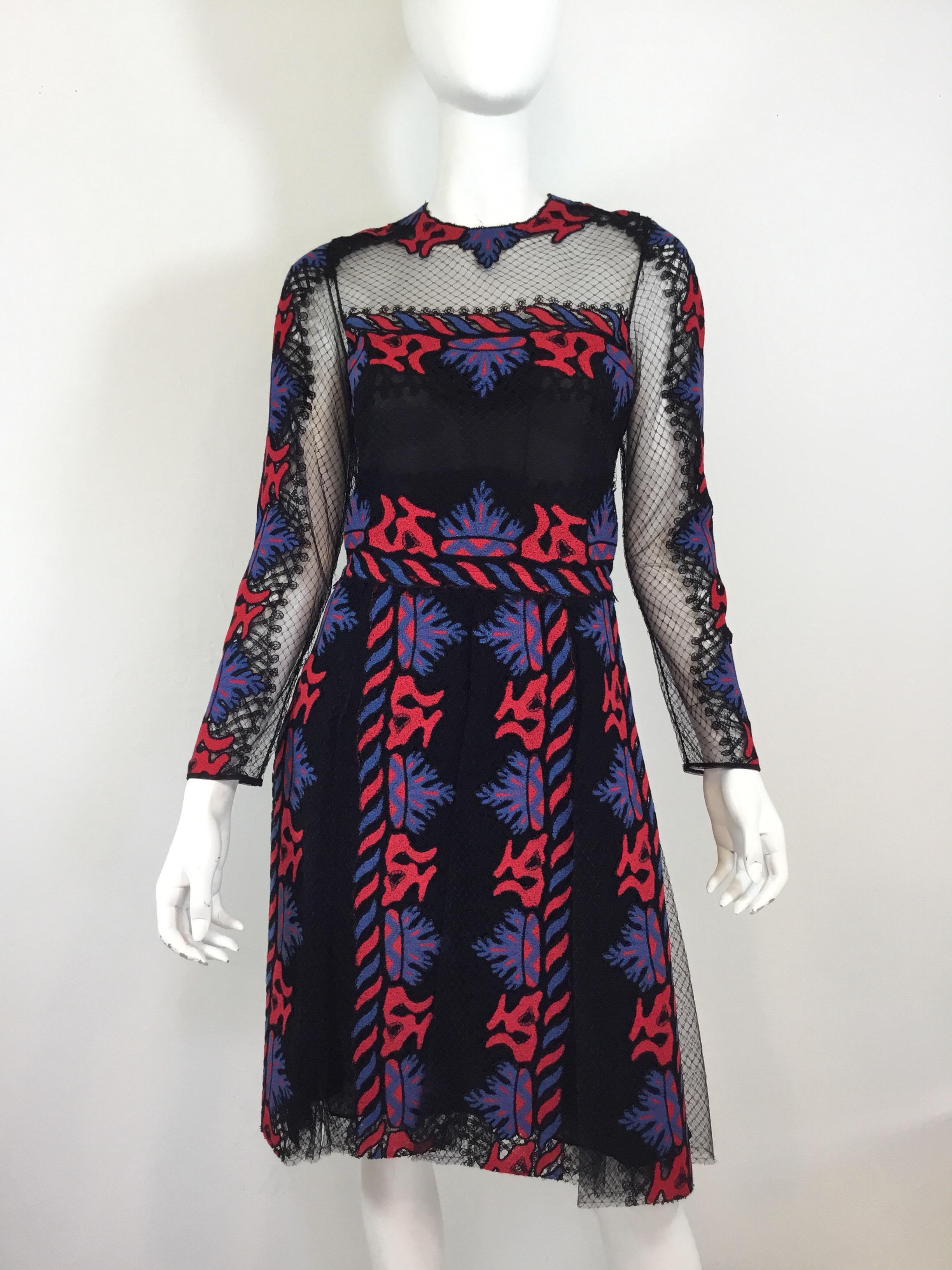 Valentino black caged dress with red and blue embroidery and a car wash Pleated skirt. Dress has a back zipper and hook fastening, size 42, made in Italy.


Bust 36”, waist 29”, hips 34”, sleeves 23”, length 40”