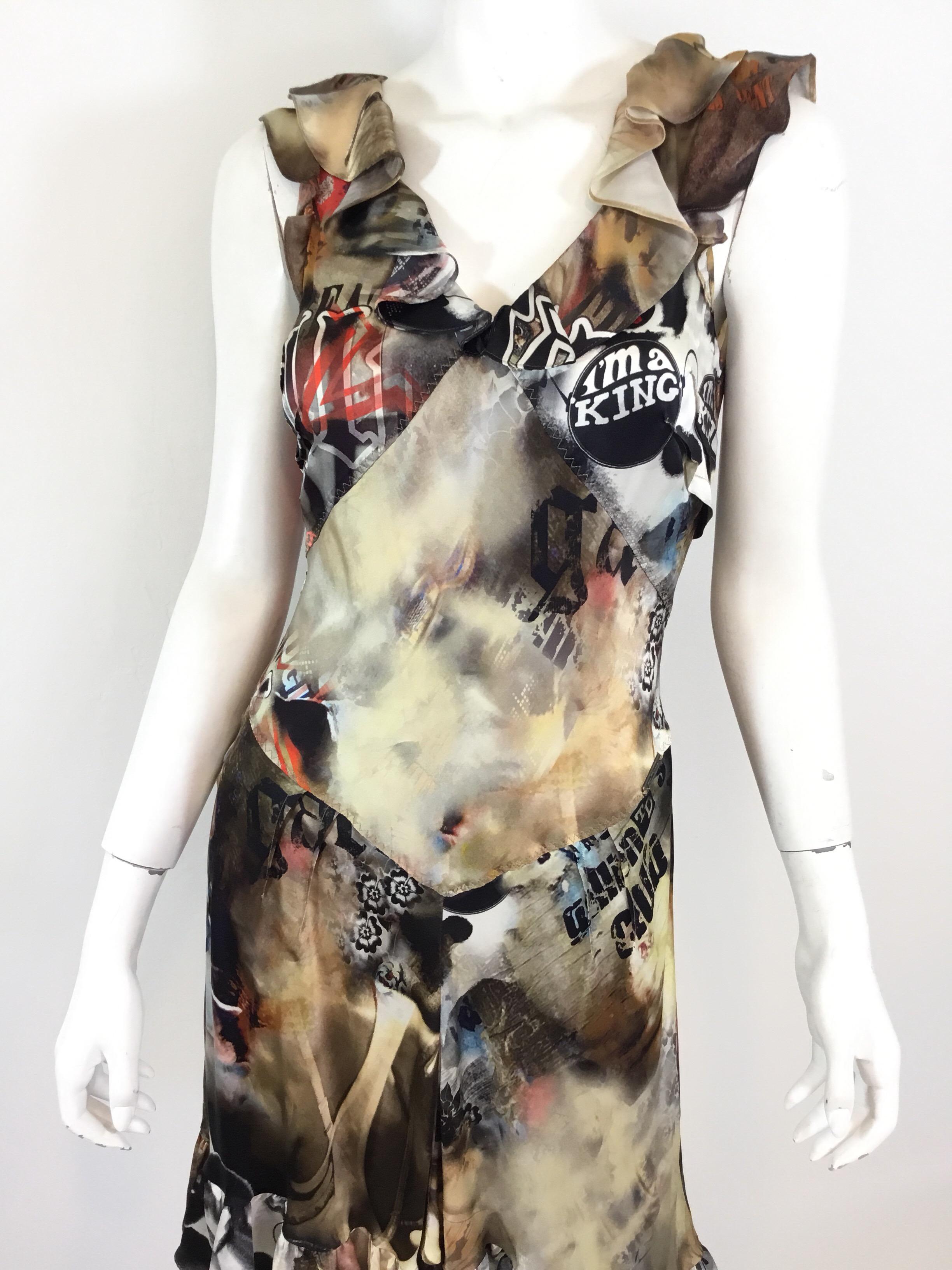 John Galliano silk dress features a multicolored Print throughout, v-neckline with a side zipper closure, ruffled hem and sleeve trim. Dress is a size 40, 100% silk.

Bust 32”, waist 28”, hips 34”, length 37”