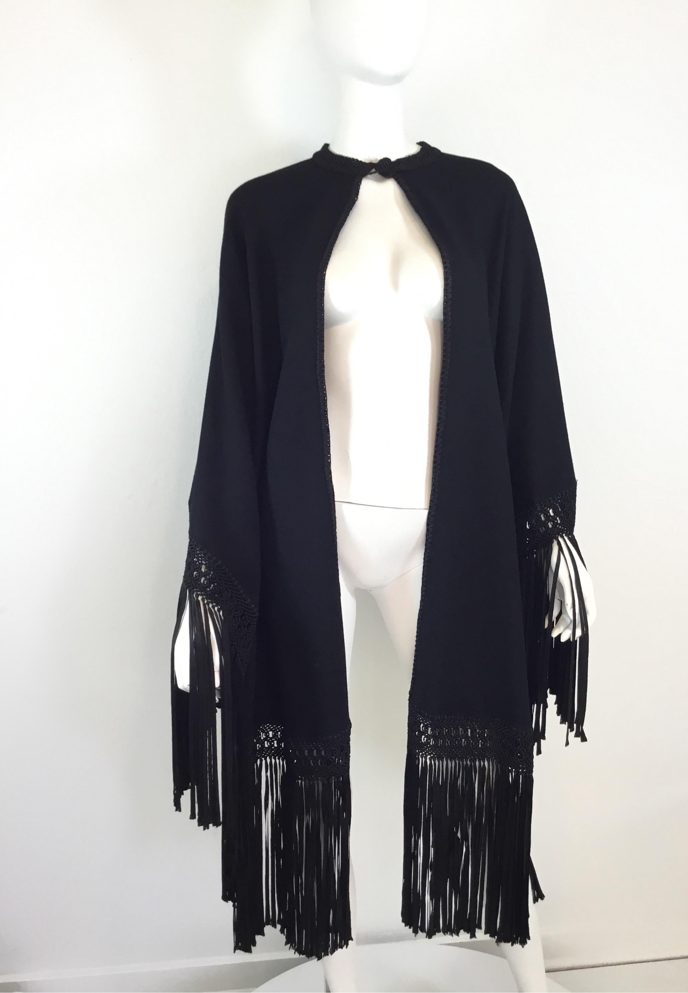 Vintage Wrap composed of wool and crepe with satin fringed detail. Wrap has a single button closure at the neck.

Length 23”