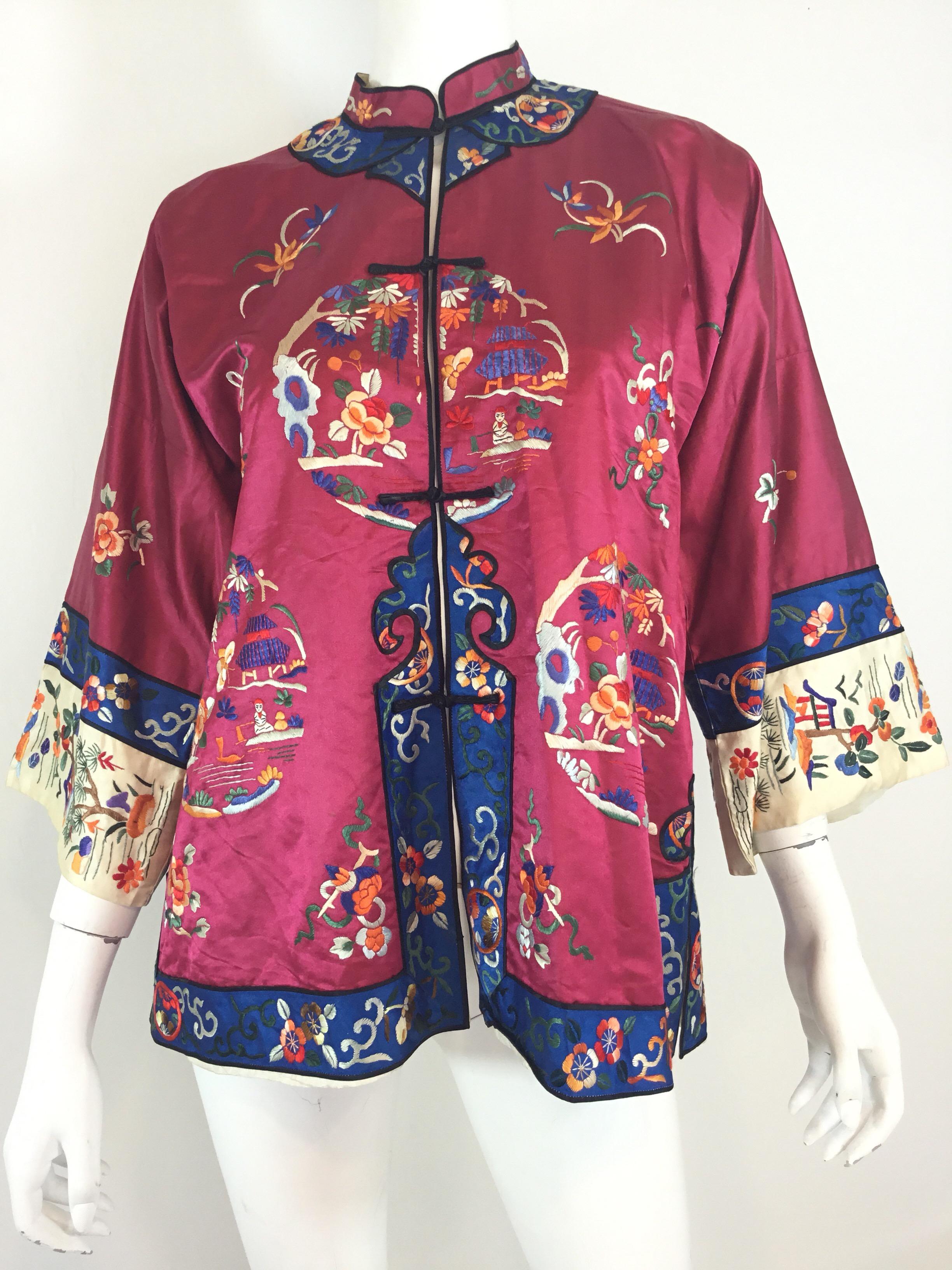 Chinese Silk Jacket, circa 1920 featured in Maroon with multicolor embroidering throughout. Jacket has button fastenings. Measurements are as follows:

Bust 40”, sleeves 12” (dolman style sleeve), length 28”