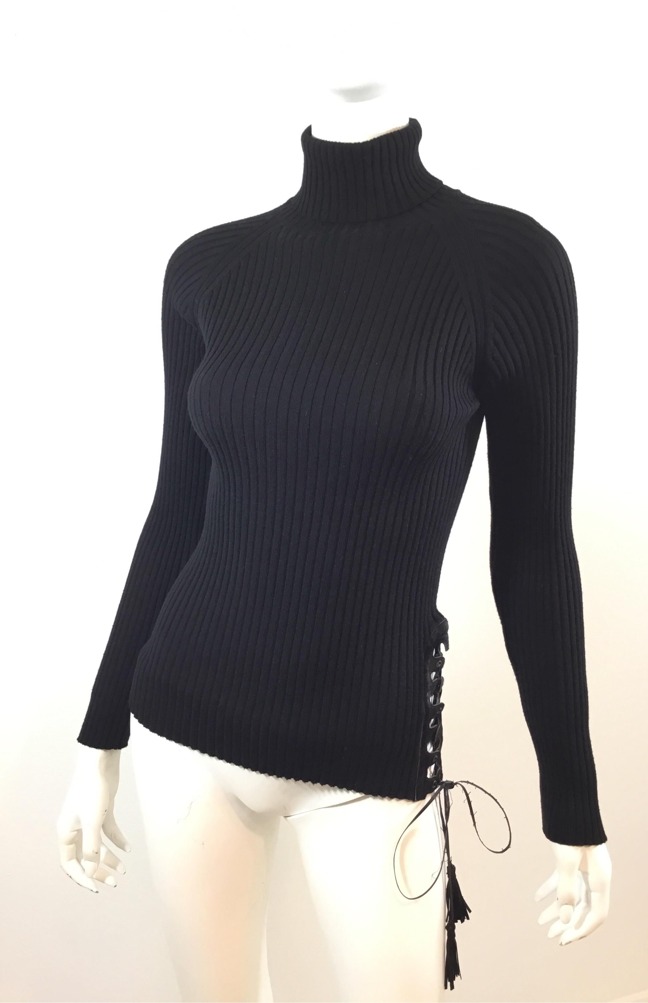 Jean Paul Gaultier Ribbed knit turtleneck features a pony fur and lace up detail along the left side hem with a leather and tassel string tie. Top is a size Medium and composed of 100% wool. Normal wears the leather string tie.

Bust 26” (some