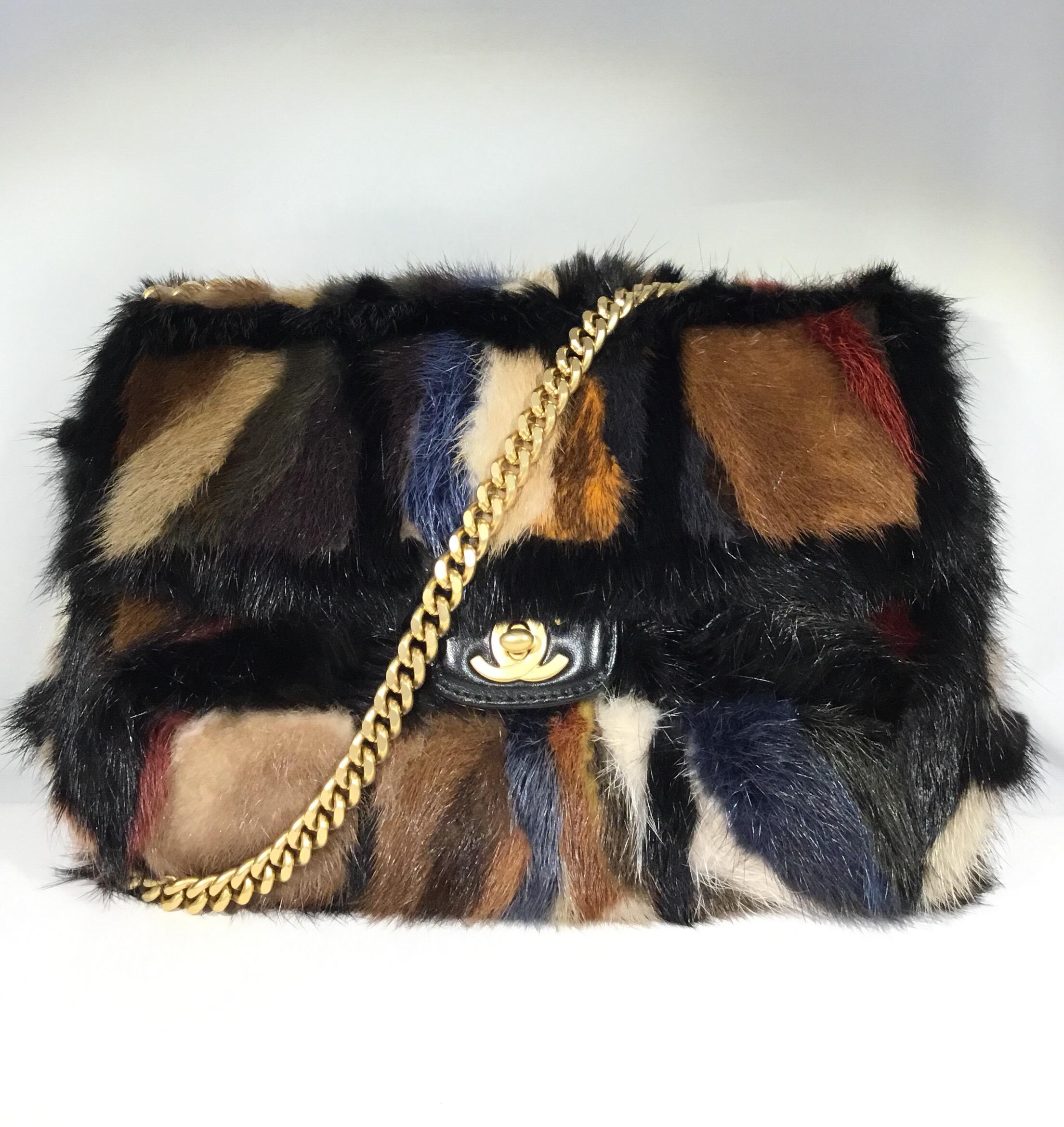 Chanel handbag features multicolored patchwork mink fur throughout with a gold-tone chain handle that is removable. Bag is fully lined in leather and has one zipper pocket. Made in Italy. Includes original dustbag.

Dimensions:
9” x 3” x 7”, Strap