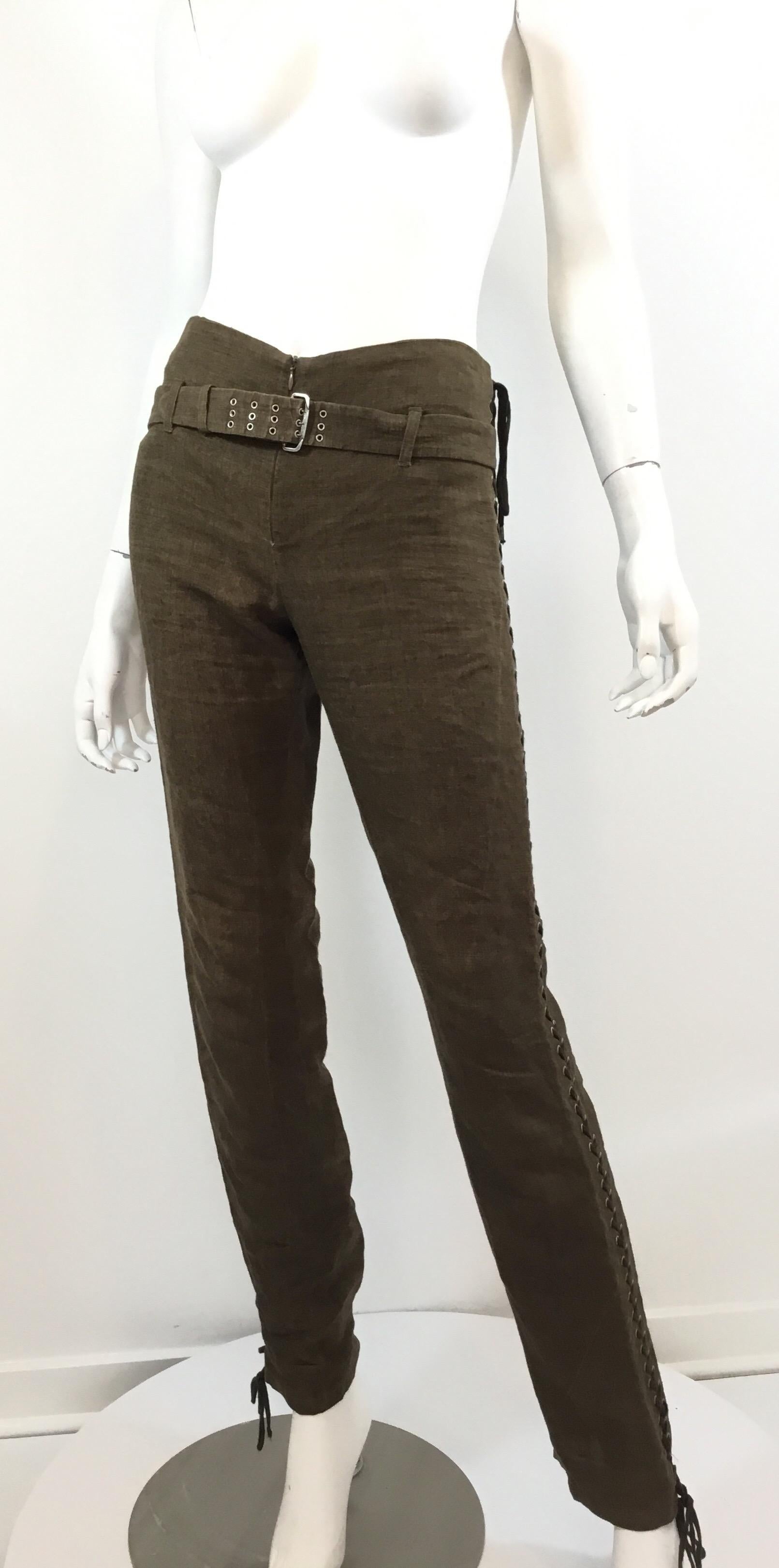 Jean Paul Gaultier linen pants featured in a dark green/brown color with a lace up and rivet panel down the sides. Pants have a zipper front and belt fastening. 100% linen, size 6, made in Italy.

Waist 30”, hips 32”, inseam 32”, rise 9”, length
