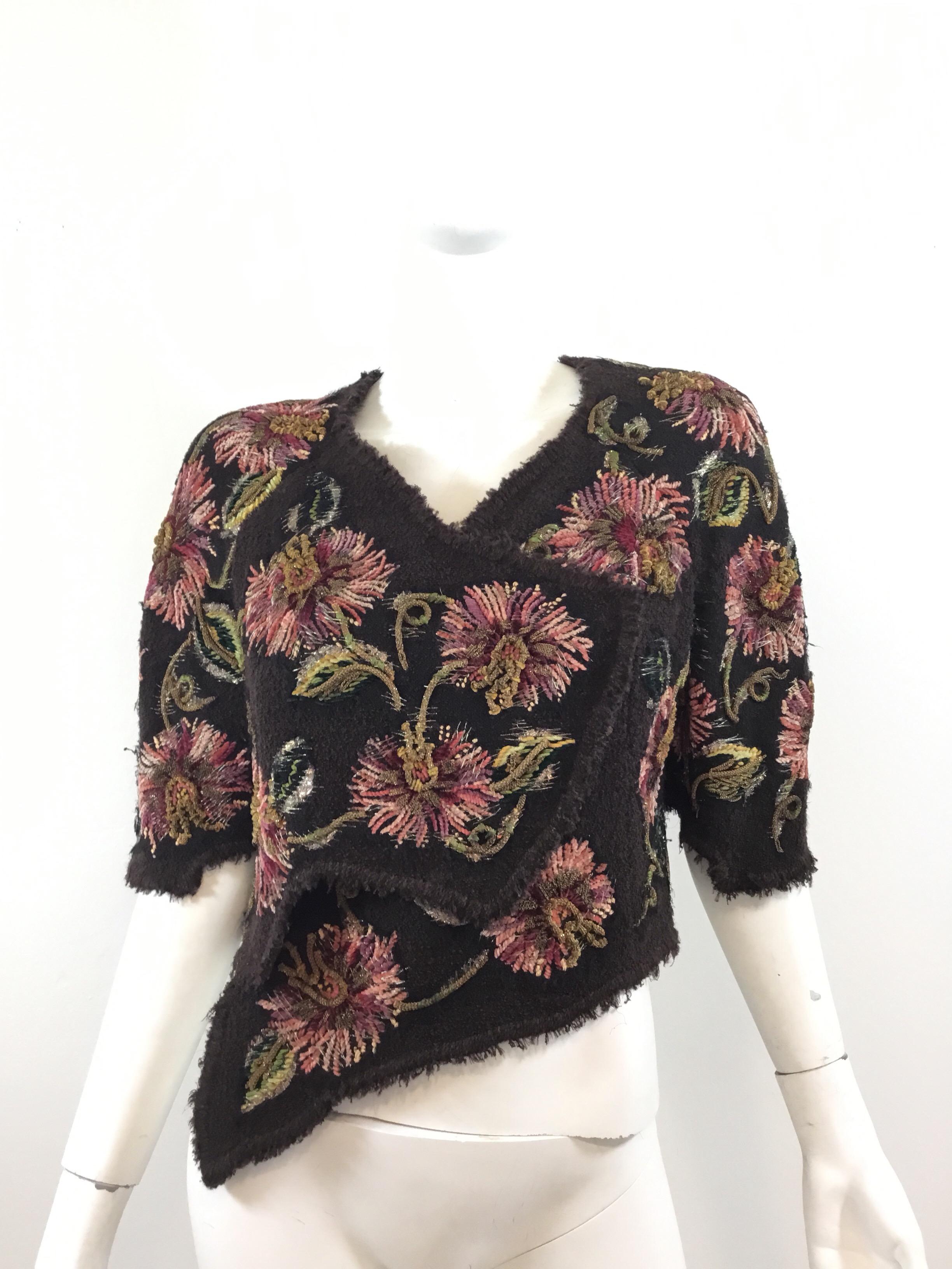 Amazing and rare Chanel Lessage embroidered tweed bolero jacket featured in a brown, wool fabric with chainwork and lamé threading throughout the floral detail. Bolero is fully lined and has concealed snap fastenings. Excellent vintage condition.