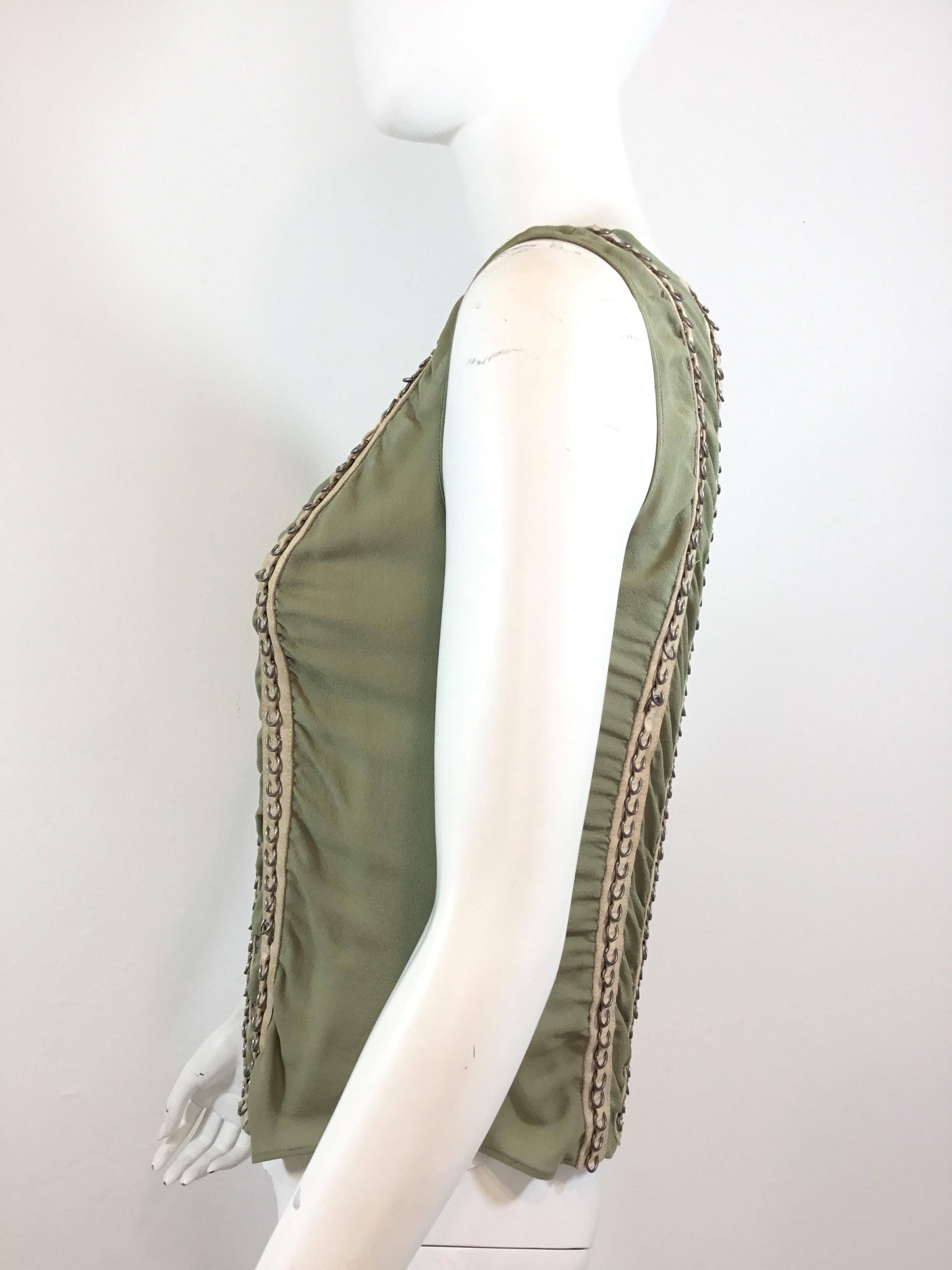 Chloé silk top featured in a pistachio green with a nude suede vertical stripe detail with silver tone rivets along the front and back. Top has a single button fastening at the back. 100% silk, made in France, size 38.

Bust 34”, length 21”