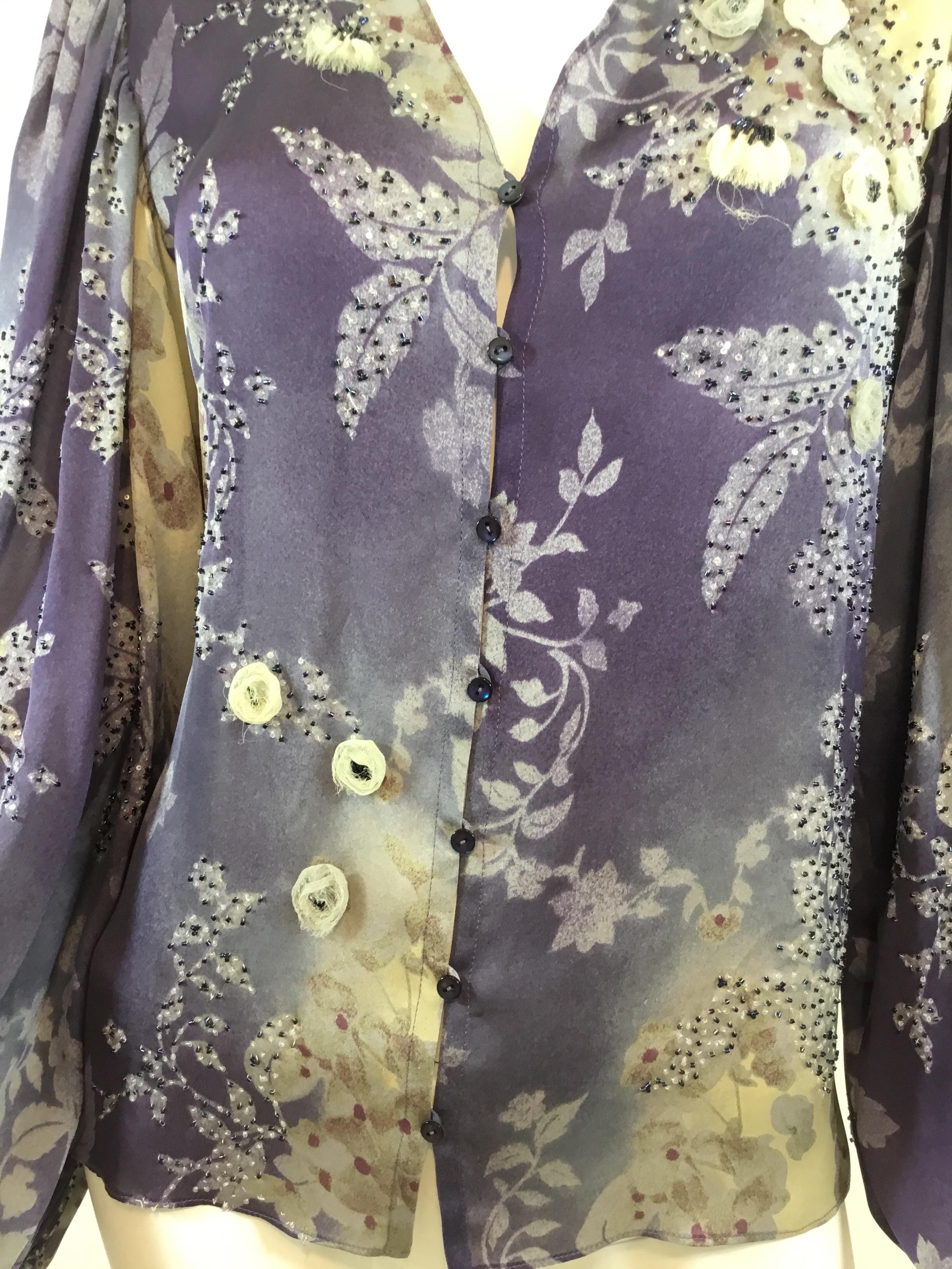 Chloé Silk blouse is featured in a blue/purple with seed bead and sequin embellishing throughout, buttoned fastenings, and billow sleeves with elasticized cuffs. Blouse is labeled a size 38, made in France, 100% silk.

Bust 36”, sleees 28”, length