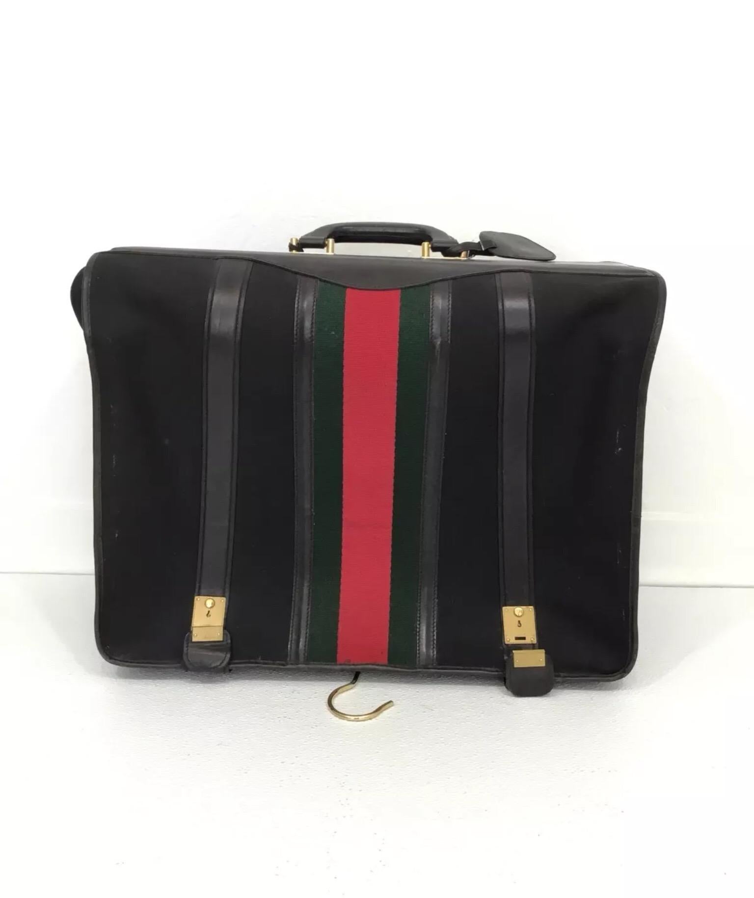 Gucci Vintage Garment Suitcase

• Gucci vintage travel suitcase features a signature red and green web stripe down the center, dual zipper closures

• Metal feet at the base to protect the canvas fabric

• Suitcase is in great vintage condition with
