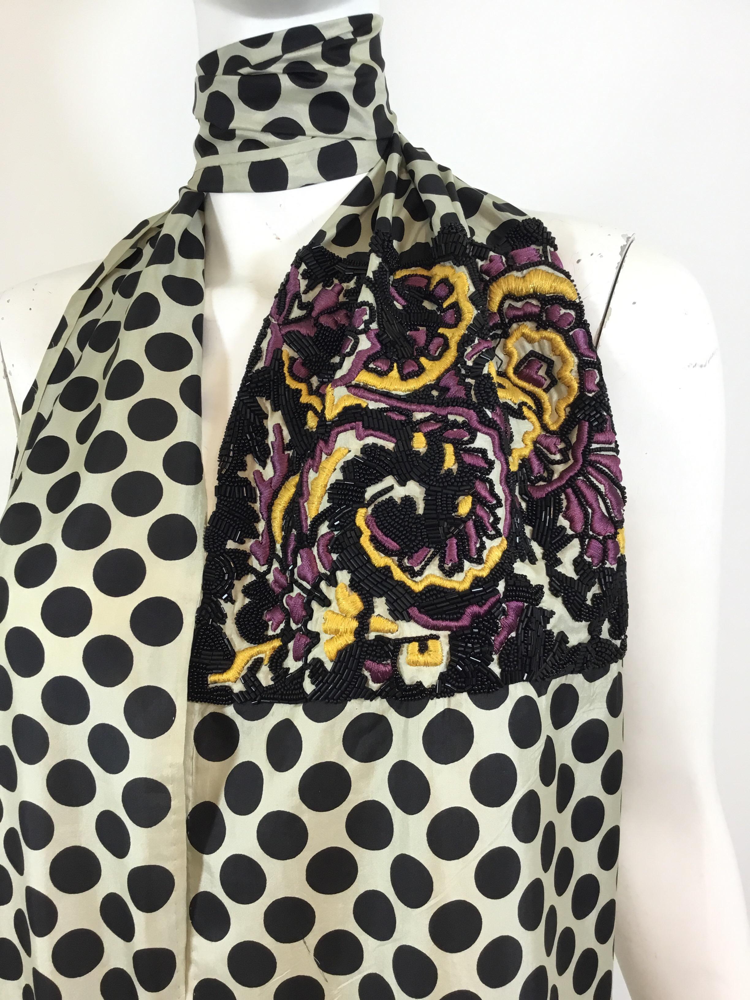 Dries Van Noten silk scarf features a polka dot pattern design throughout —  lack with a beige background. Scarf has fringed ends, golden yellow and purple embroidery detail and black beads. There is one small snag and two very unnoticeable pulls to