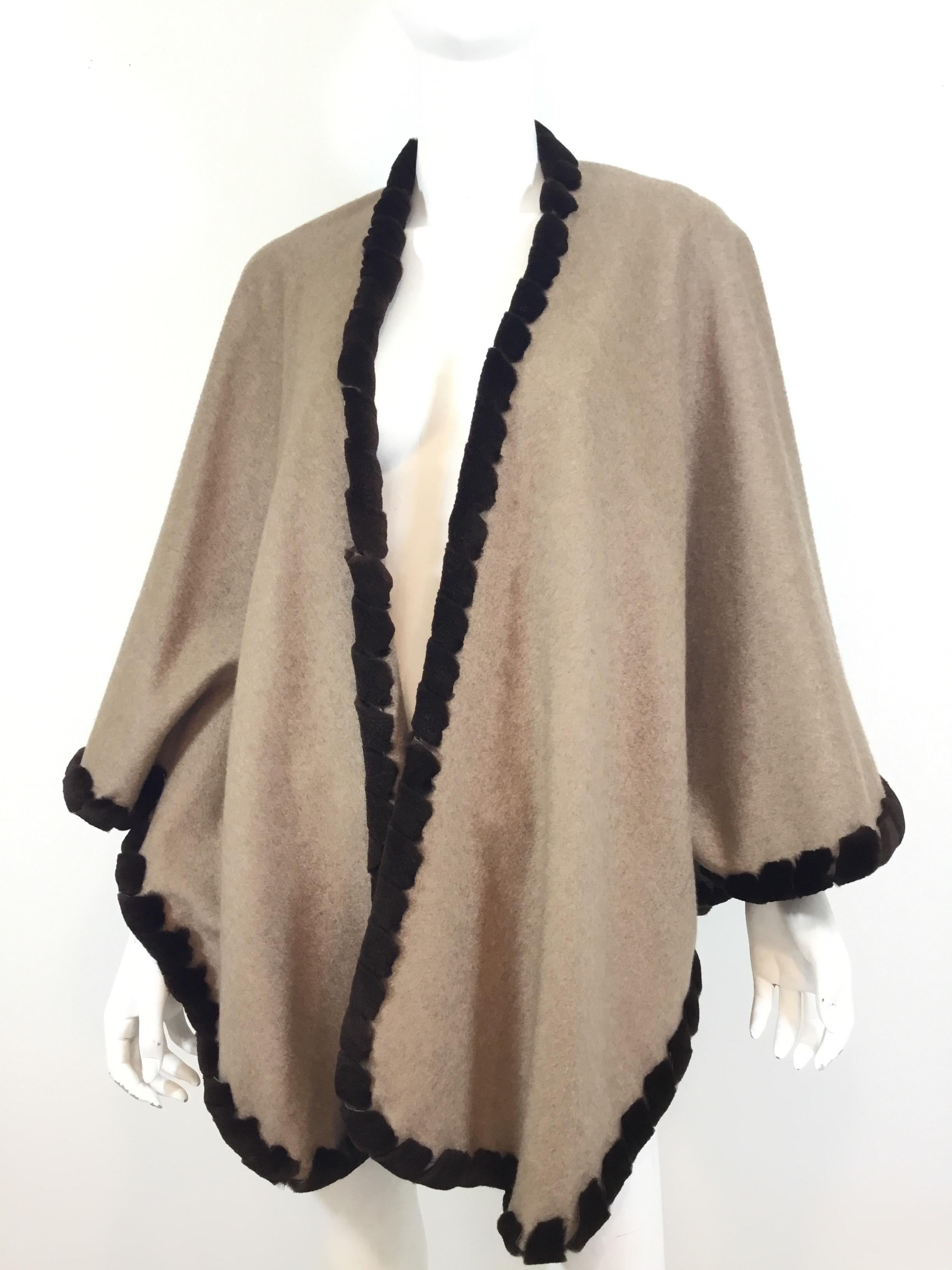 Loro Piana cashmere cape featured in a taupe color with a brown sheared mink trim. Optional buttons to create an insert for arms. Estimated retail $10k. Made in Italy. 100% cashmere.

 Bust (laying flat) 38” across, length 30”
