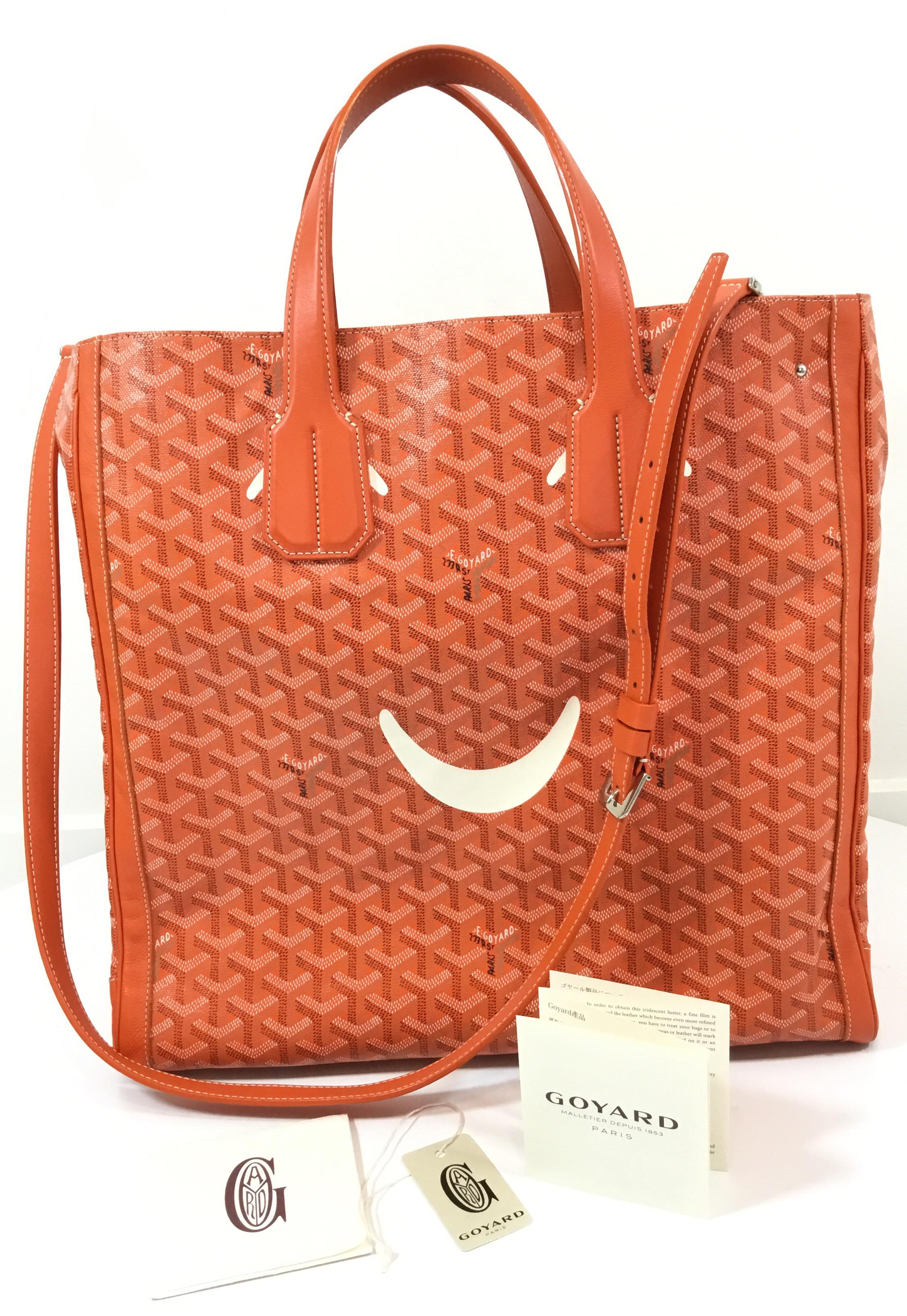Goyard Voltaire Smile tote crafted in iconic Goyardine orange and multicolored canvas with reinforced leather edges, palladium hardware, 'Smiley' face accent at front exterior, single detachable shoulder strap, marigold canvas lining, dual flat top