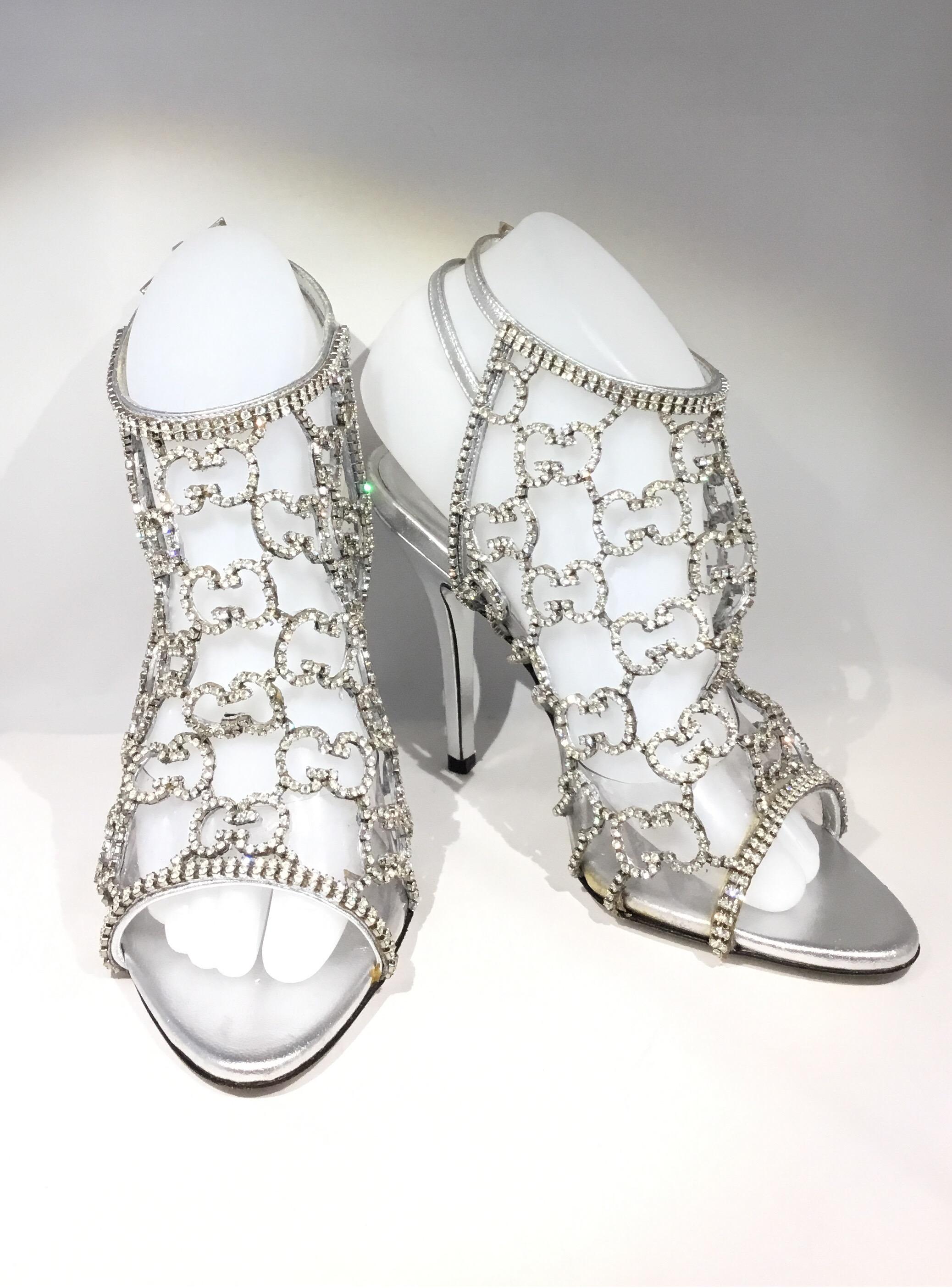 Gucci rhinestone-encrusted Heels featured in silver with its signature GG monogram and dual ankle strap fastenings. Leather soles and insoles. Shoes are labeled size 37 C, made in Italy. Heels have normal wears, see photos. Retail $5k

Heel height