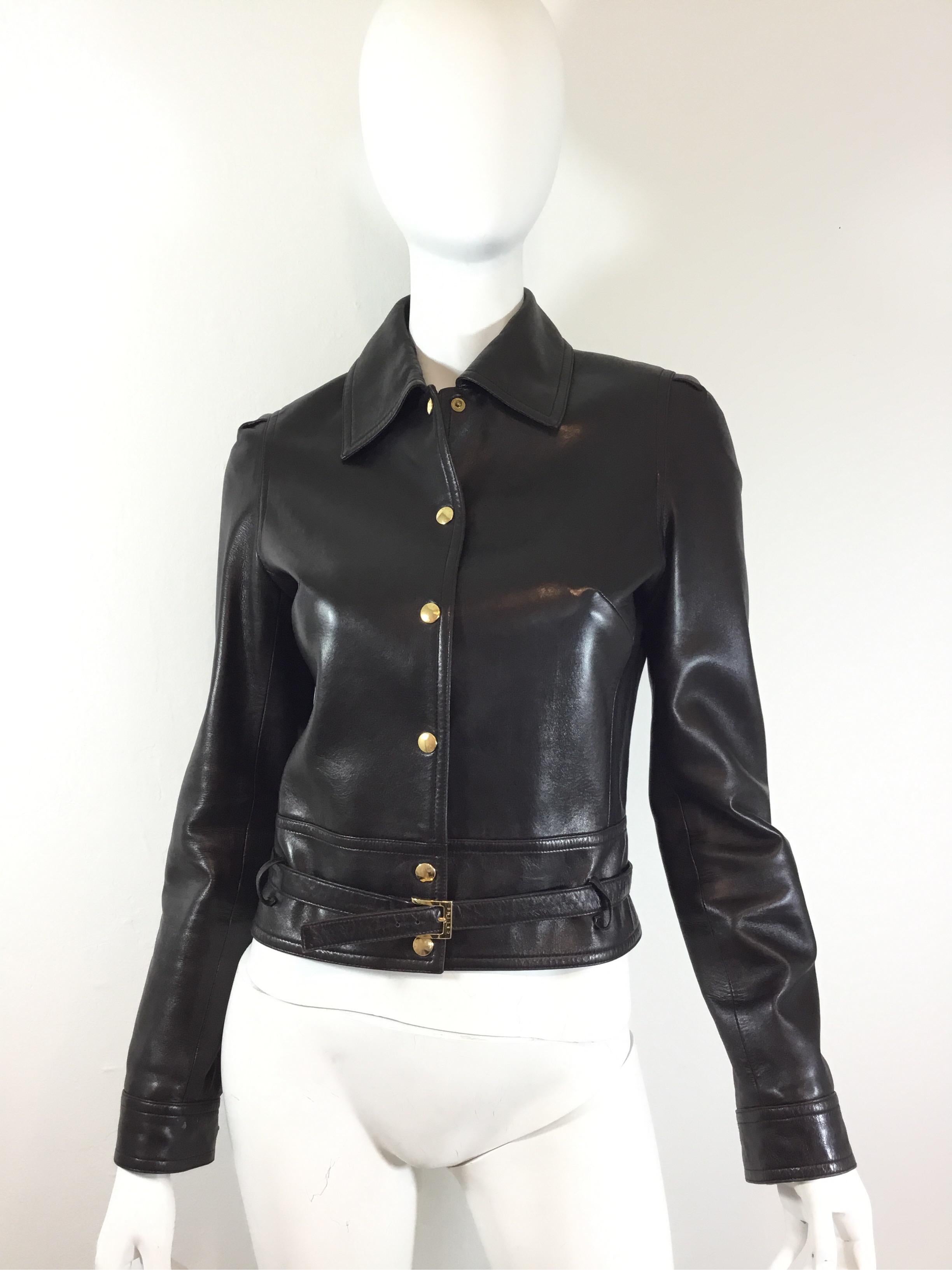 Celine jacket featured in a dark brown with gold tone snap button fastenings and a Belted waist. 100% lambskin leather and fully lined. Jacket is a size 38, made in France.

Bust 38”, sleeves 26”, shoulder to shoulder 14”, length 21”