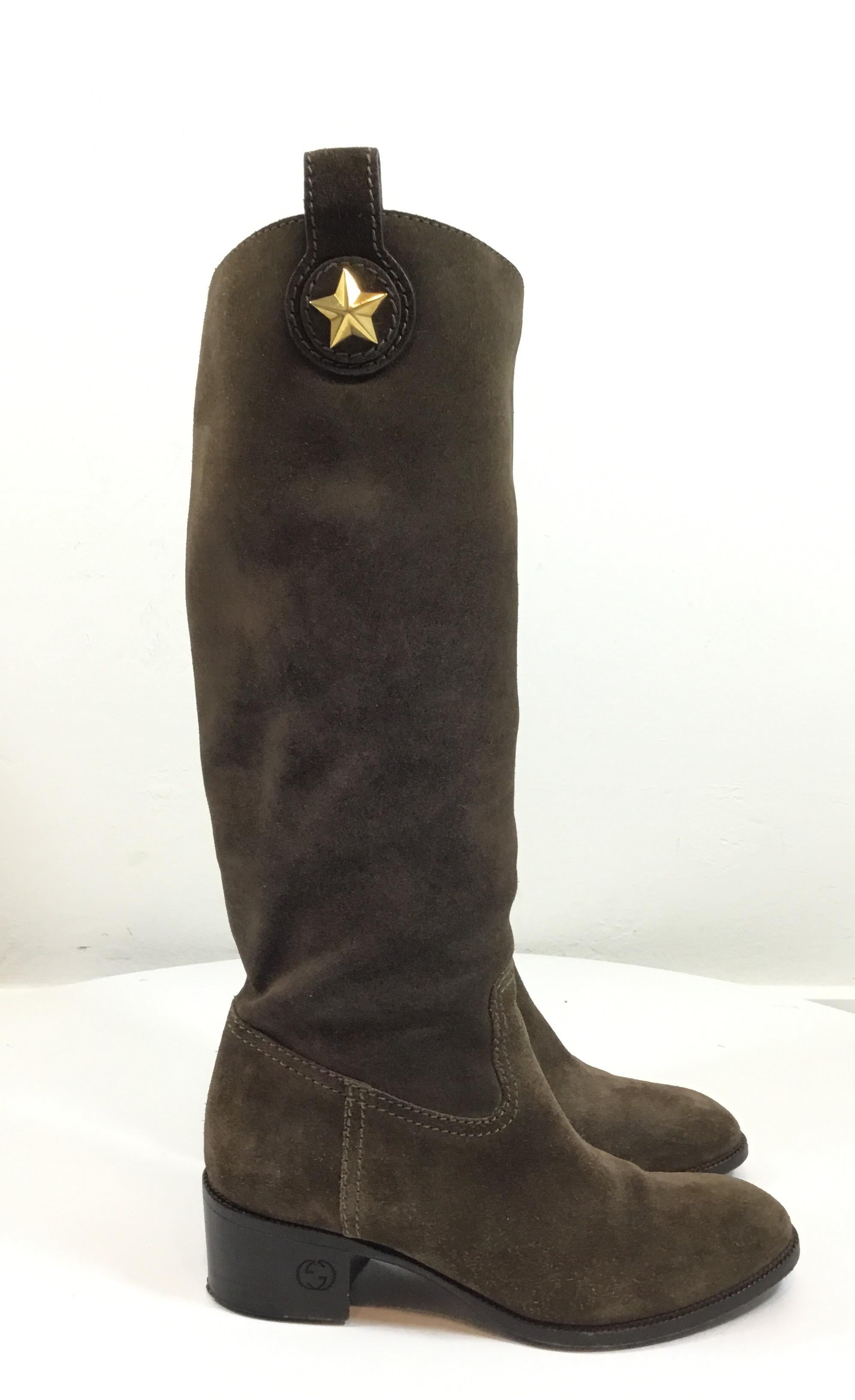 Gucci Suede Brown Boots w/ Gold Star Detail featured in Size 6. Excellent condition. Normal light wear to suede.

Height from top of heel to top of boot 14 in

Heel height 1 3/4 in

Calf opening 14 1/2 in
