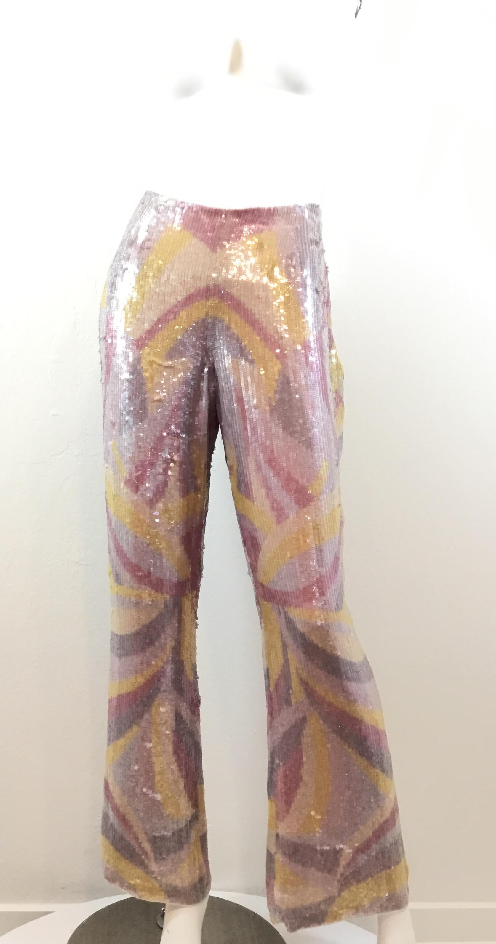Escada pants featured in soft pastel colors fully covered in sequins with a beaded trim along the waist. Pants are 100% silk and fully lined, size 42.

Waist 32”
Hips 40”
Inseam 30”
Rise 10”
Length 40”

Pants are NEW with tags but do have some minor
