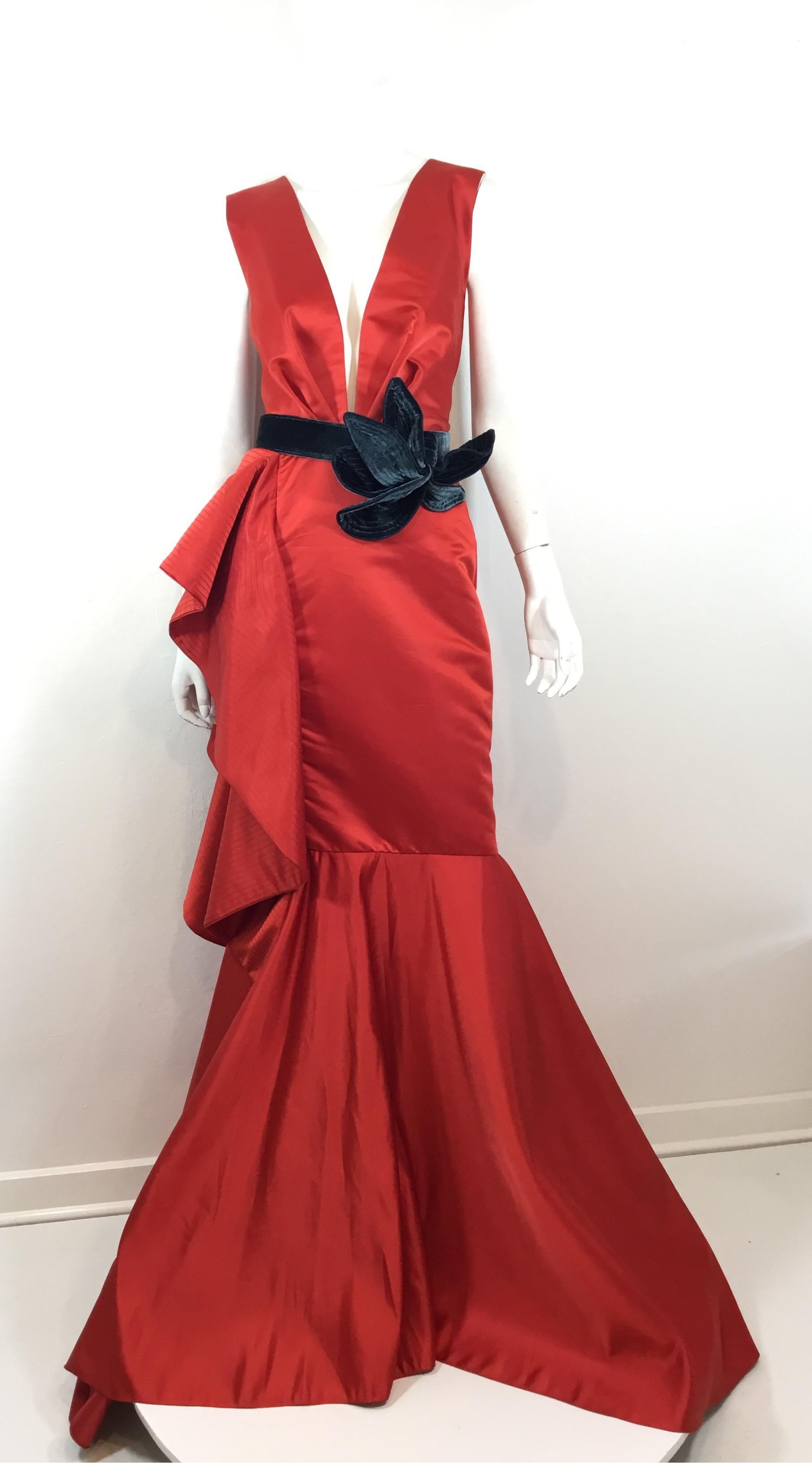 Johanna Ortiz beautiful red gown from the Fall 2016 collection features a plunging neckline, mermaid/Fluted hem, back zipper fastening, and a velvet belt. Gown is a size 6 and composed of a polyester and acetate fabric blend. Excellent