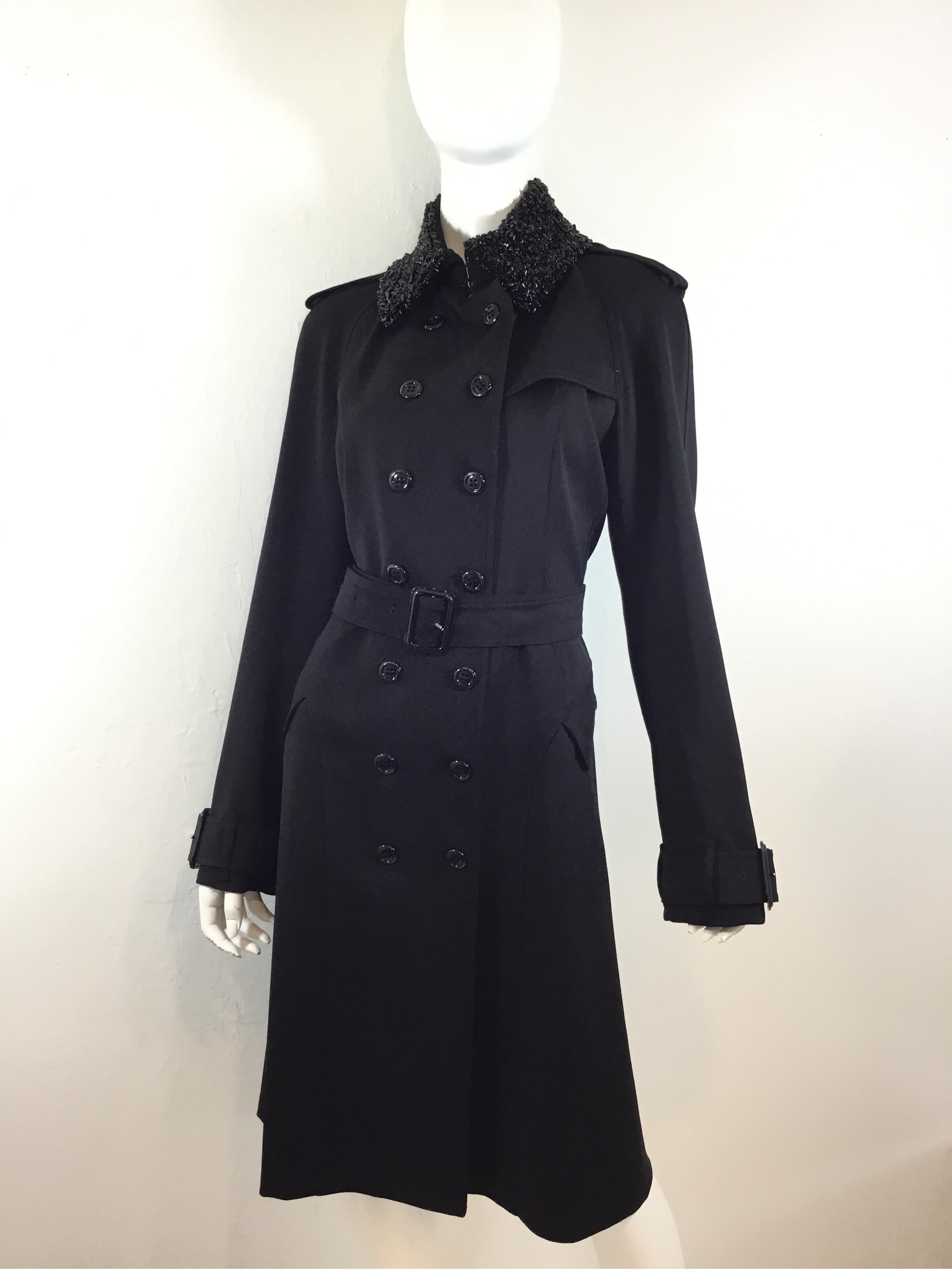 Burberry black gabardine trench coat features button fastenings, waist belt, and a beaded collar. Coat is in excellent like-new condition. 100% virgin wool. Labeled size US 12/ IT 46, made in Italy.

Measurements: Bust 41'', waist 38'', length 44'',