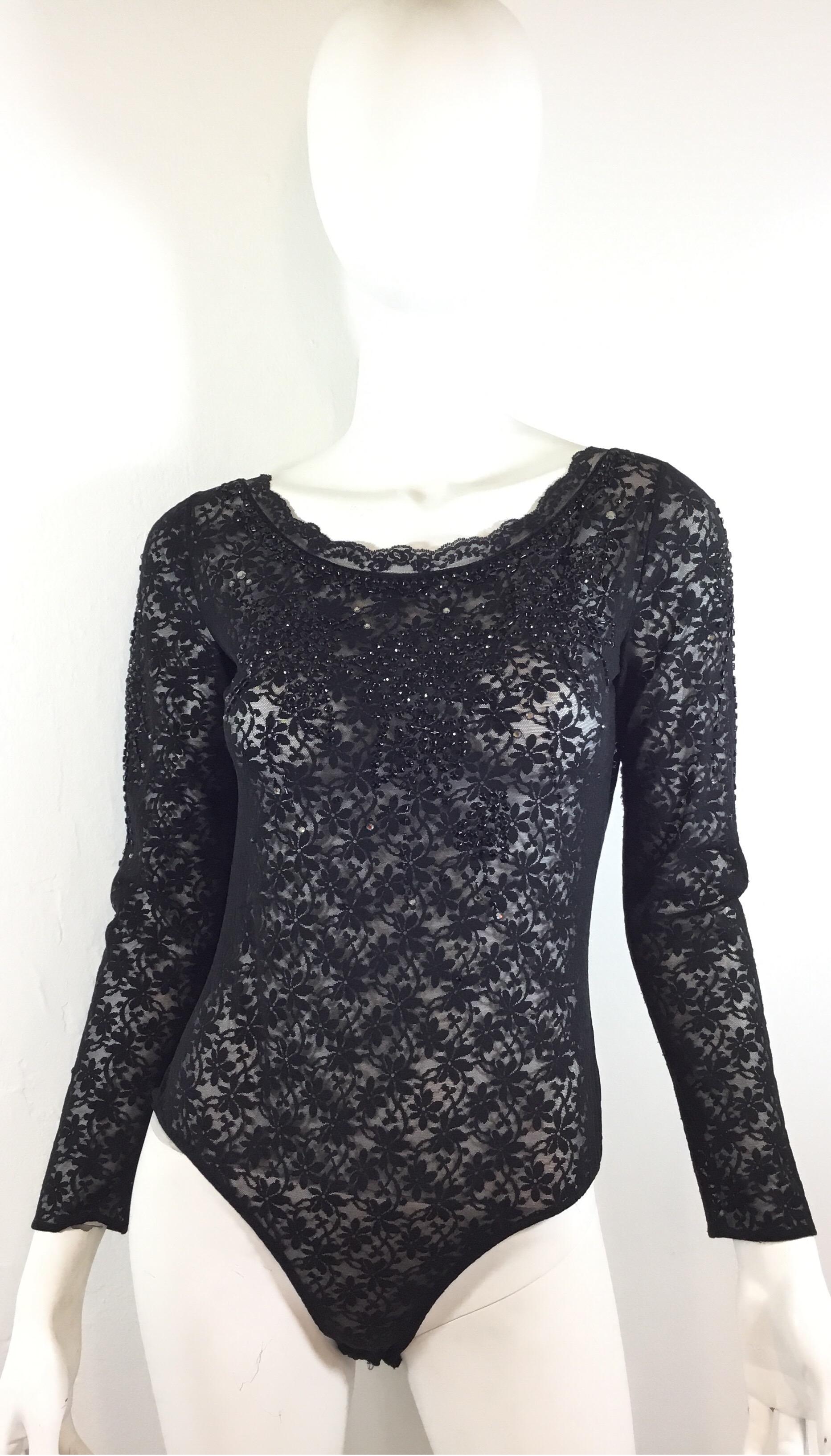 Giorgio Sant’Angelo full lace bodysuit features beading along the front, back, and sleeves. Bodysuit has snap fastenings and a keyhole design at the back with a hook fastening. Labeled size 10. Excellent condition.

Bust 34”, sleeves 21.5”, length