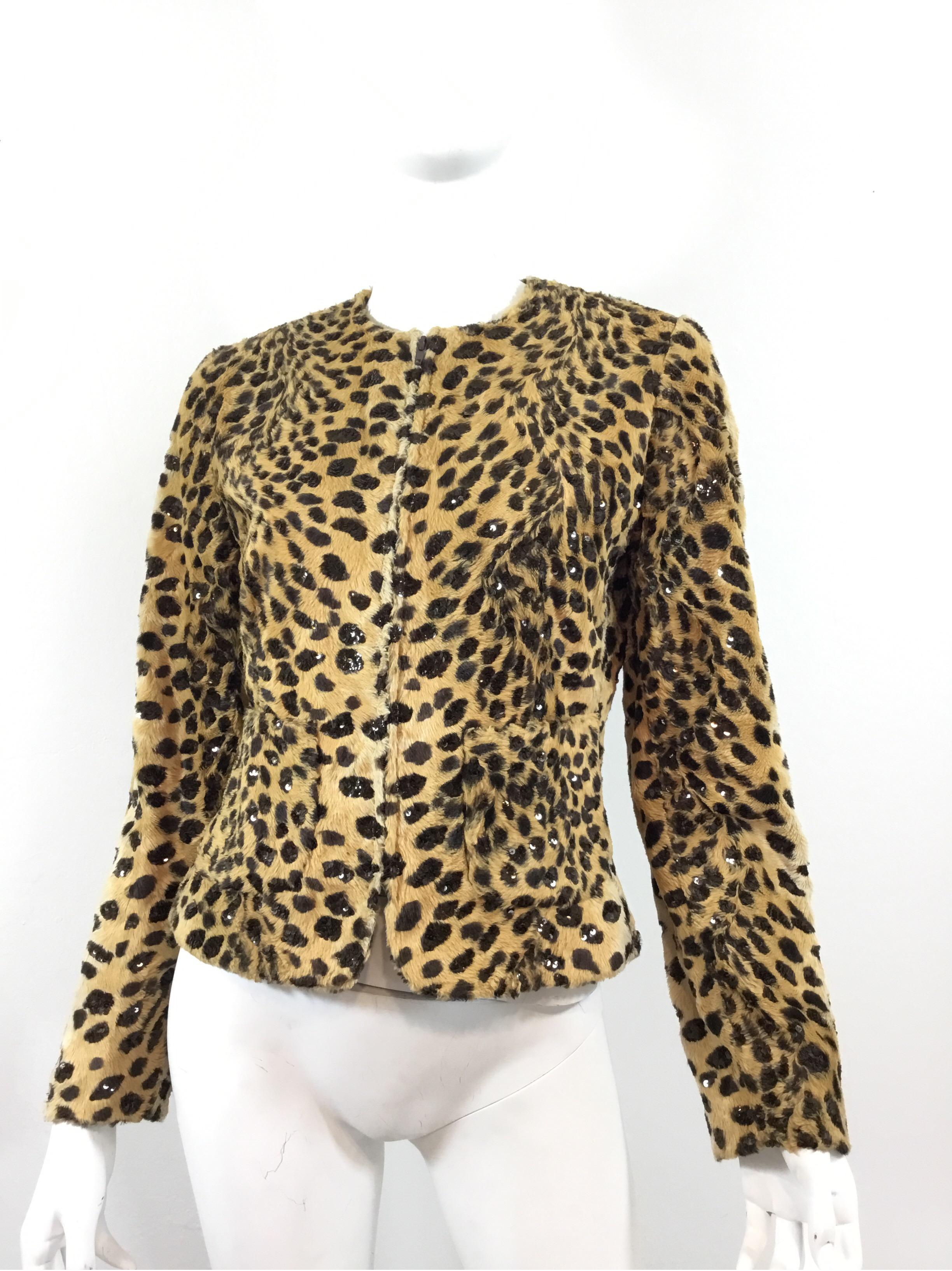 Valentino Miss V jacket features an animal print design throughout adorned with sequins, two slip pockets, front zipper fastening and a full lining. Jacket is a size 42/8, made in Italy, and is composed of: 62% cotton, 38% rayon and lining 65%