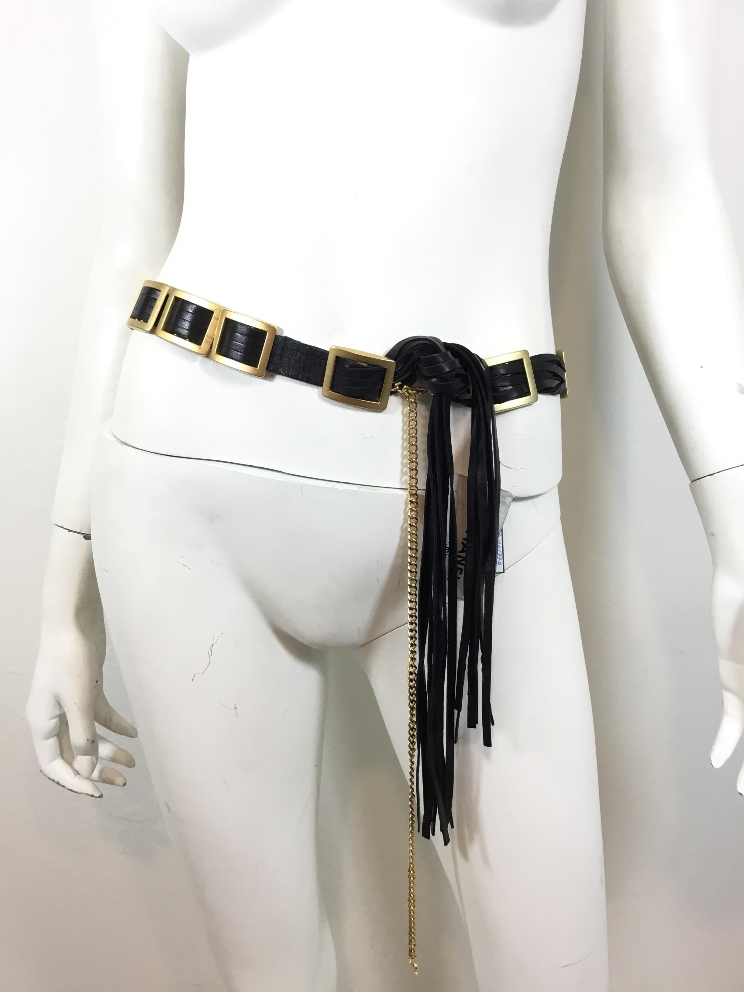 Chanel Black leather strand belt with goldtone metal plates, clip closure. Belt is brand new with tags and measures approximately 60 inches and 1 inch wide.