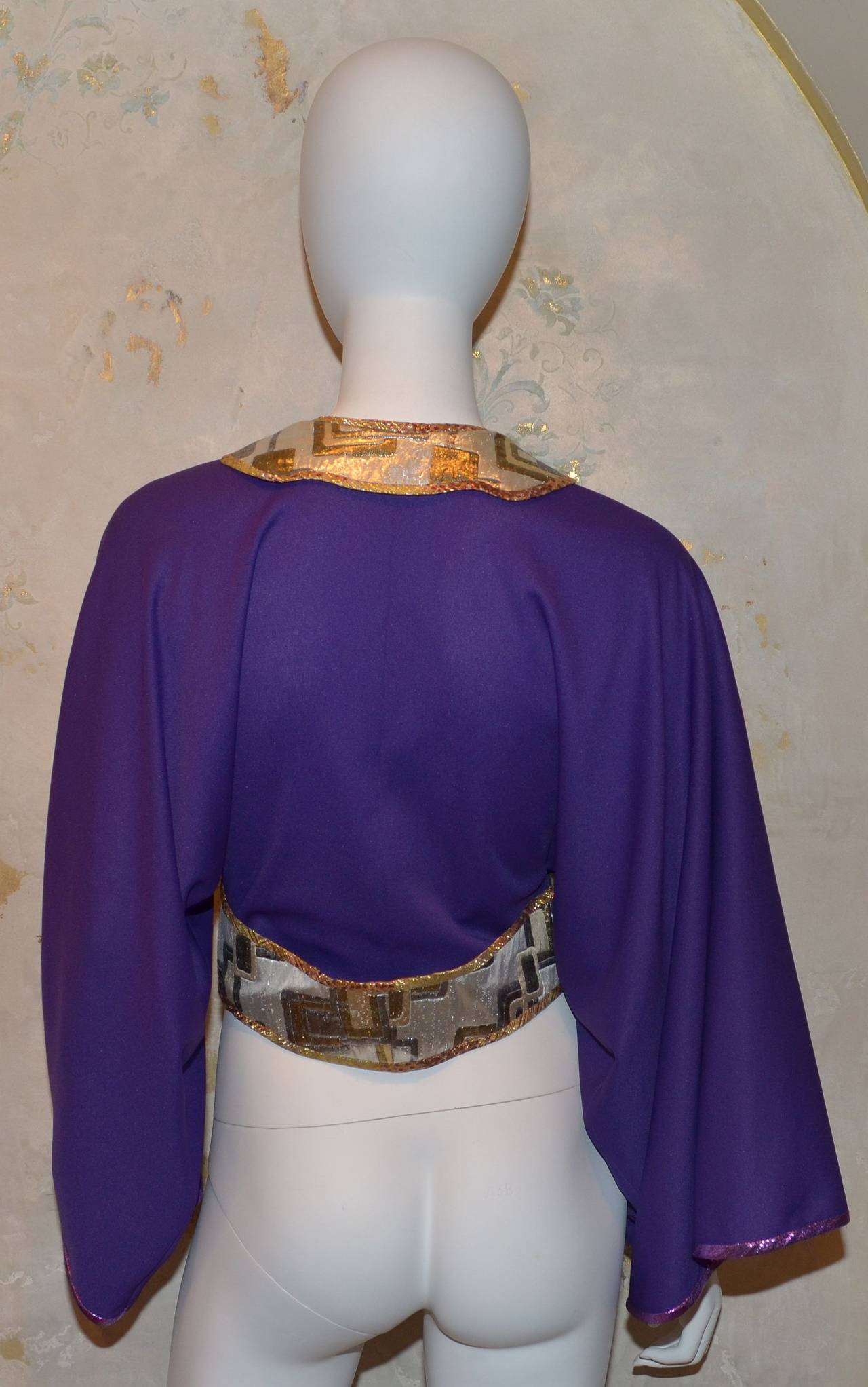 Handmade Kaisik Wong jersey kimono jacket has a metal zipper front closure, silver, gold, and multi-colored brocade waistband and collar.

Kaisik Wong of San Francisco was the pioneer of Wearable Art. His creations were exquisite and all handmade